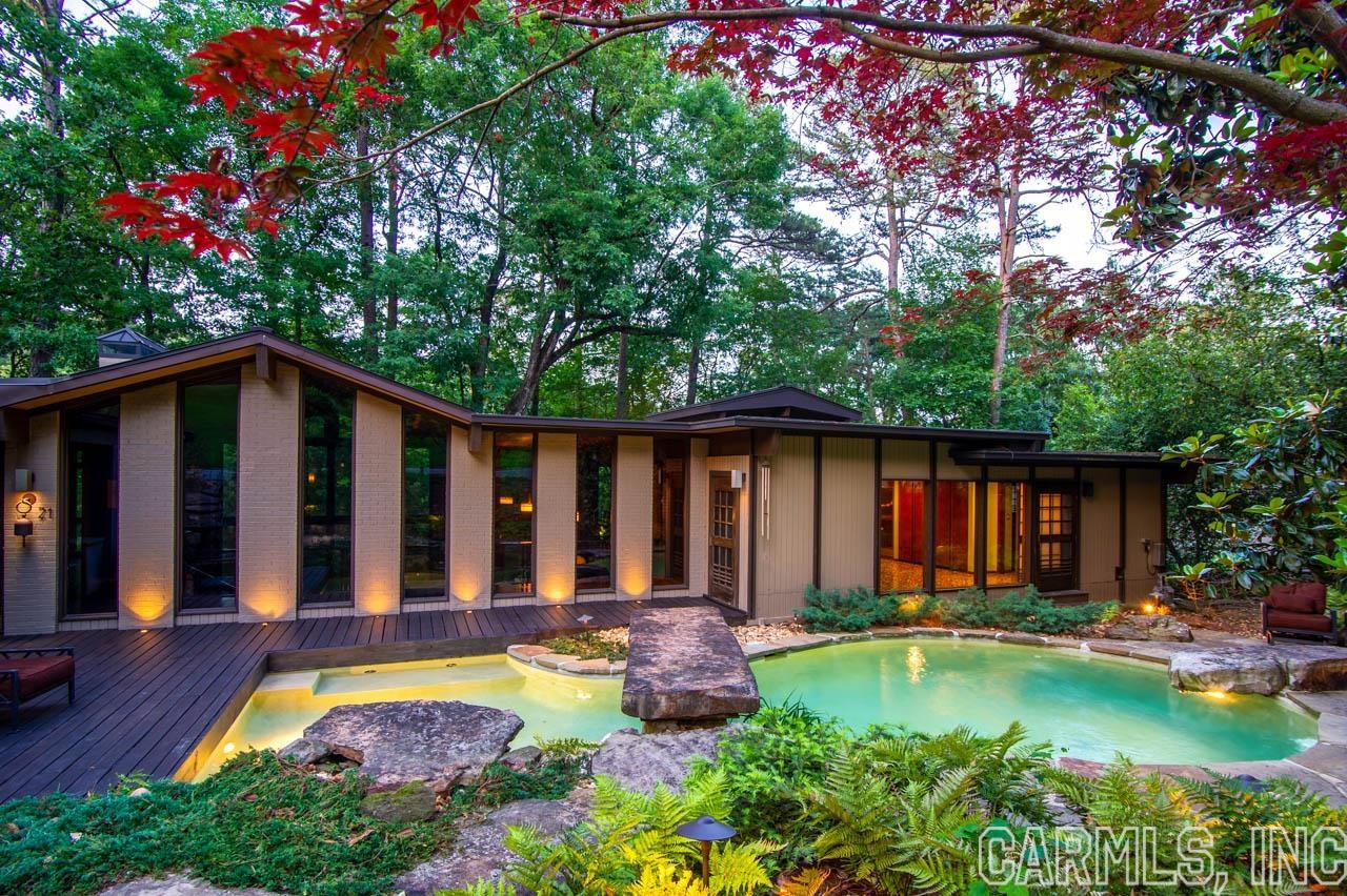 Built in 1966, this mid-century modern home sits on over 1/2 acre that backs up to a 24-acre greenbelt in the centrally located River Ridge neighborhood. Over the years, the home has been thoughtfully upgraded while preserving its wonderful mid-century charm. The floor-to-ceiling windows in the main living space will make you feel like you're in a modern treehouse, while the sunken living room, double-sided fireplace, and built-in bar seem straight out of an episode of Mad Men! With 4 bedrooms, 2 1/2 baths, and almost 6,000sf, there's plenty of space. The spacious kitchen features a stunning copper vent hood and high-end appliances. The one-of-a-kind master bedroom has a charming fireplace, while the stunning master bath is your own personal spa with a whirlpool tub, steam shower, large in-floor hot tub, sauna, and the closets of your dreams! The huge laundry/utility room has loads of extra storage, and the pool is unlike any you've seen in the state, with gorgeous stonework and beautiful landscaping. An outdoor cooktop, sink, and firepit make this home ideal for entertaining or escaping from day-to-day worries. Agents-see remarks.