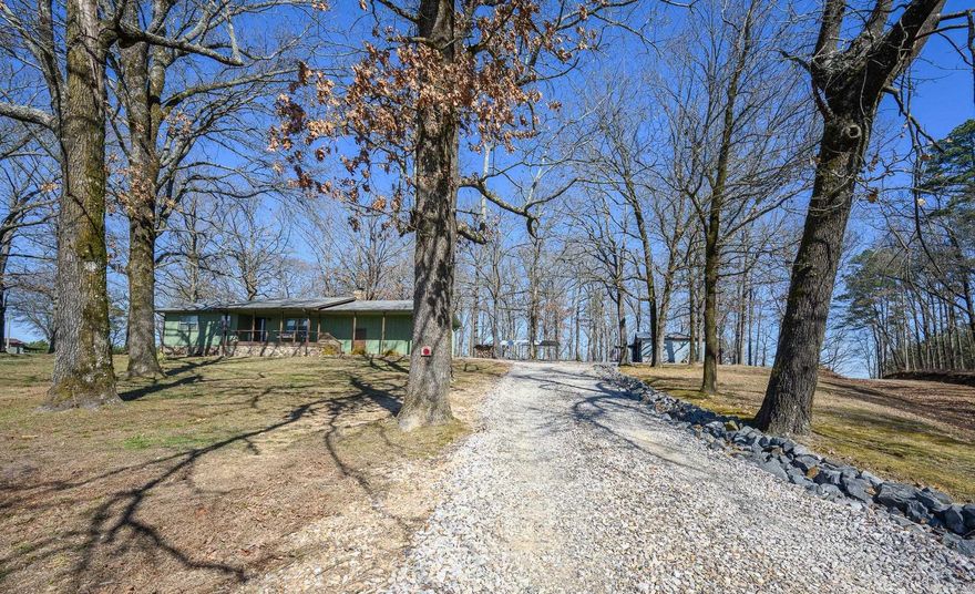 If you’ve been waiting for a place that feels like your own private Arkansas retreat, you just found it. Tucked into a pine-lined, park-like setting, this gorgeously remodeled home sits like a hidden basecamp, complete with a private pond for fishing, quiet evenings under the stars, and deer that don’t just wander through, they pour out of the timber. Inside, the remodel is the kind you don’t see every day, clean, high-end, and truly move-in ready. The primary suite is next-level: two bedrooms were combined to create an oversized retreat with a huge walk-in closet and a gigantic bathroom that feels like a private spa. Every space flows with comfort and intention, making this home feel equal parts stylish and livable. Outside is where the lifestyle really shows up: multiple outbuildings give you room for tools, toys, projects, and hunting/fishing gear. There’s even a converted conex container set up for secure storage/workshop use, perfect for the person who needs real utility, not just “a shed." This is the kind of property that lets you live the way you’ve talked about living: cast a line in your own pond, watch wildlife from your own yard, and keep adventure within easy reach!