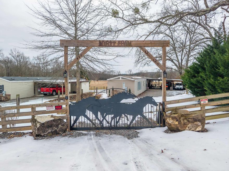 This expansive estate offers a rare combination of residential versatility and premium agricultural infrastructure, making it an ideal multi-family investment or a private sanctuary. The property features six or more rental units, ranging from a cozy 2 bedroom one bath (the old farm house) to two 2bed 2bath & three 3/2 mobile homes providing a substantial, steady income stream. At the heart of the acreage sits a scenic, stocked pond creating a tranquil focal point for the meticulously landscaped grounds. Practicality is paramount, evidenced by a large, multi-bay shop and a dedicated detached garage, offering ample climate-controlled space for vehicle maintenance, equipment storage, or a private collection. For the equestrian enthusiast, the property boasts a professional-grade six-stall barn. Each stall is thoughtfully designed with high-quality flooring and Dutch doors for optimal ventilation. The barn is seamlessly integrated with a dedicated workshop, providing a specialized environment for farrier work, tool repairs, or creative projects without intruding on the livestock's peace. This versatile layout balances high-end residential living with functional farm utility.