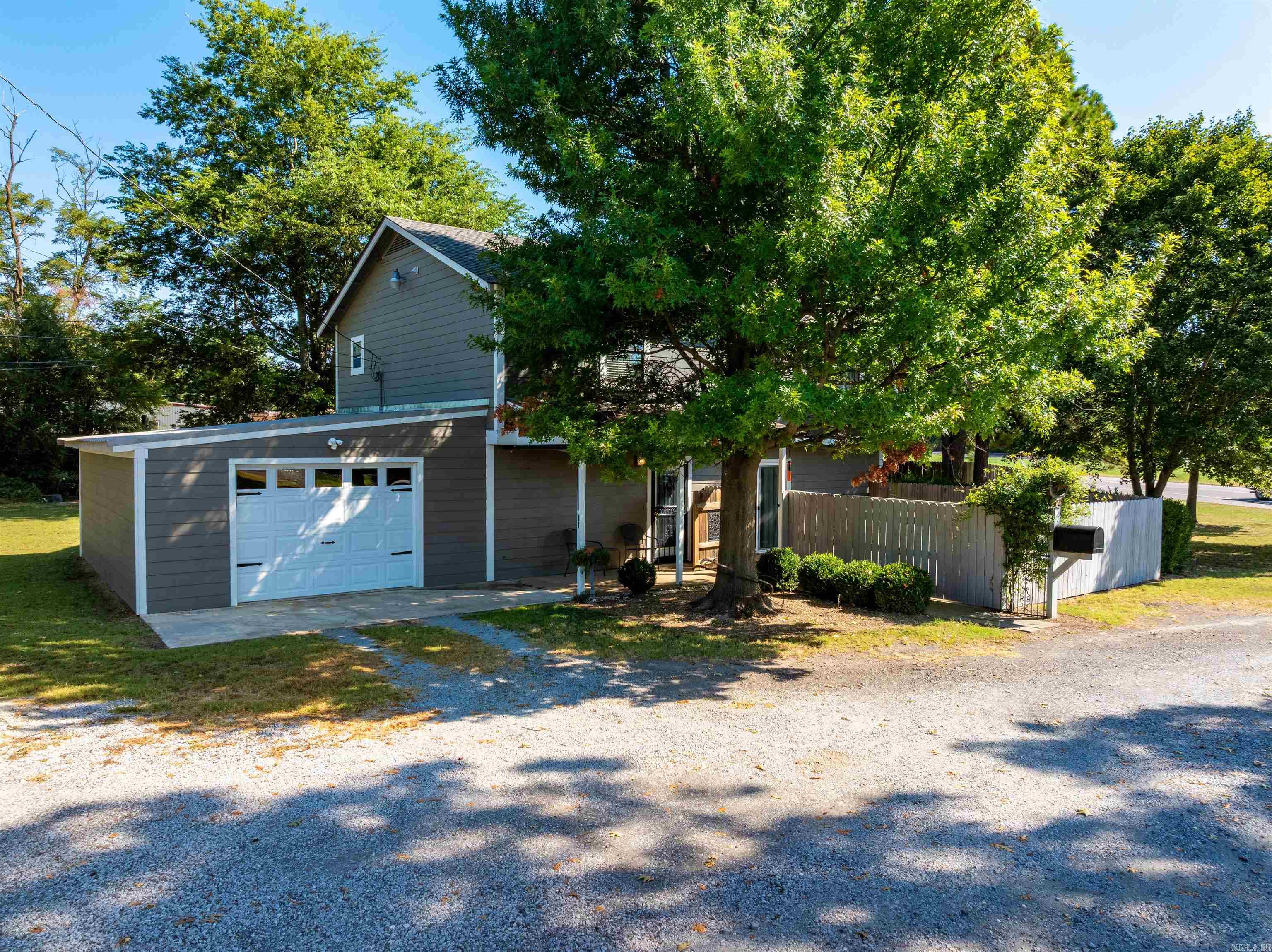 This well-maintained home sits on 3 lots totaling about 1 acre just outside of Tuckerman, offering updates, space, and thoughtful features. Surrounded by shade trees, the property includes a privacy-fenced patio plus a separate fenced backyard, perfect for pets. Built in 1995, the home has received many updates, including fresh interior/exterior paint, a new roof in 2024, and newer garage and patio additions. The main level features a welcoming living room with gas fireplace, a kitchen with gas cook stove and large pantry, a bedroom, full bath, and a bonus room with doggie door to the backyard. Upstairs offers 2 bedrooms, a sitting area, full bath, large laundry with sink and folding island, and a second living room with walkout access. The seller will install new carpet (buyerās choice) in one room prior to closing. Extras include a full-house generator, storm shelter, circle drive, and utilities including city sewer, Entergy electric, Summit natural gas, and Optimum internet. This home is clean, move-in ready, and designed for comfort with flexible living spaces and modern updates.