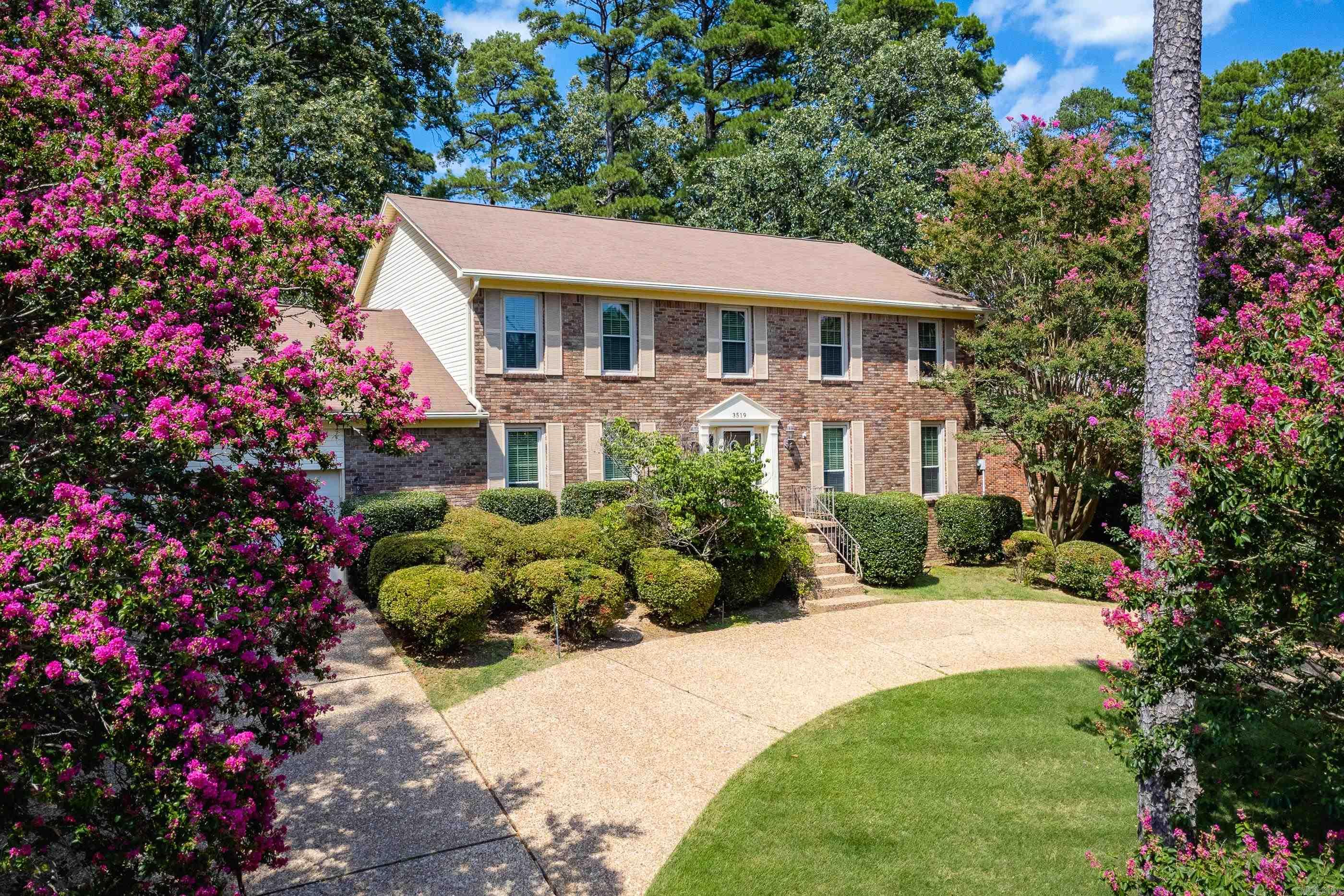 Traditional Colonial style two story brick home in sought after Pleasant Valley with timeless curb appeal. Brick exterior with a classic design, large windows, and mature landscaping. Center hall foyer opens to formal living and dining rooms on each side. Spacious family room features fireplace, built-ins, and wet bar. Newer wood floors on main level, new neutral carpet upstairs. Large kitchen with excellent workspace, two pantries, and informal dining area with bay window overlooking newer back deck. Main level bedroom suite (currently used as a game room) offers flexible use as a primary or in-law suite. Upstairs includes three generous bedrooms, hall bath, and second primary suite with attached bath. Large backyard with beautiful mature trees, circular drive, and two car garage with storage. New roof, windows and gutters 2024. Well kept home on a large lot in a great neighborhood ready for you to make it your own. Come see!