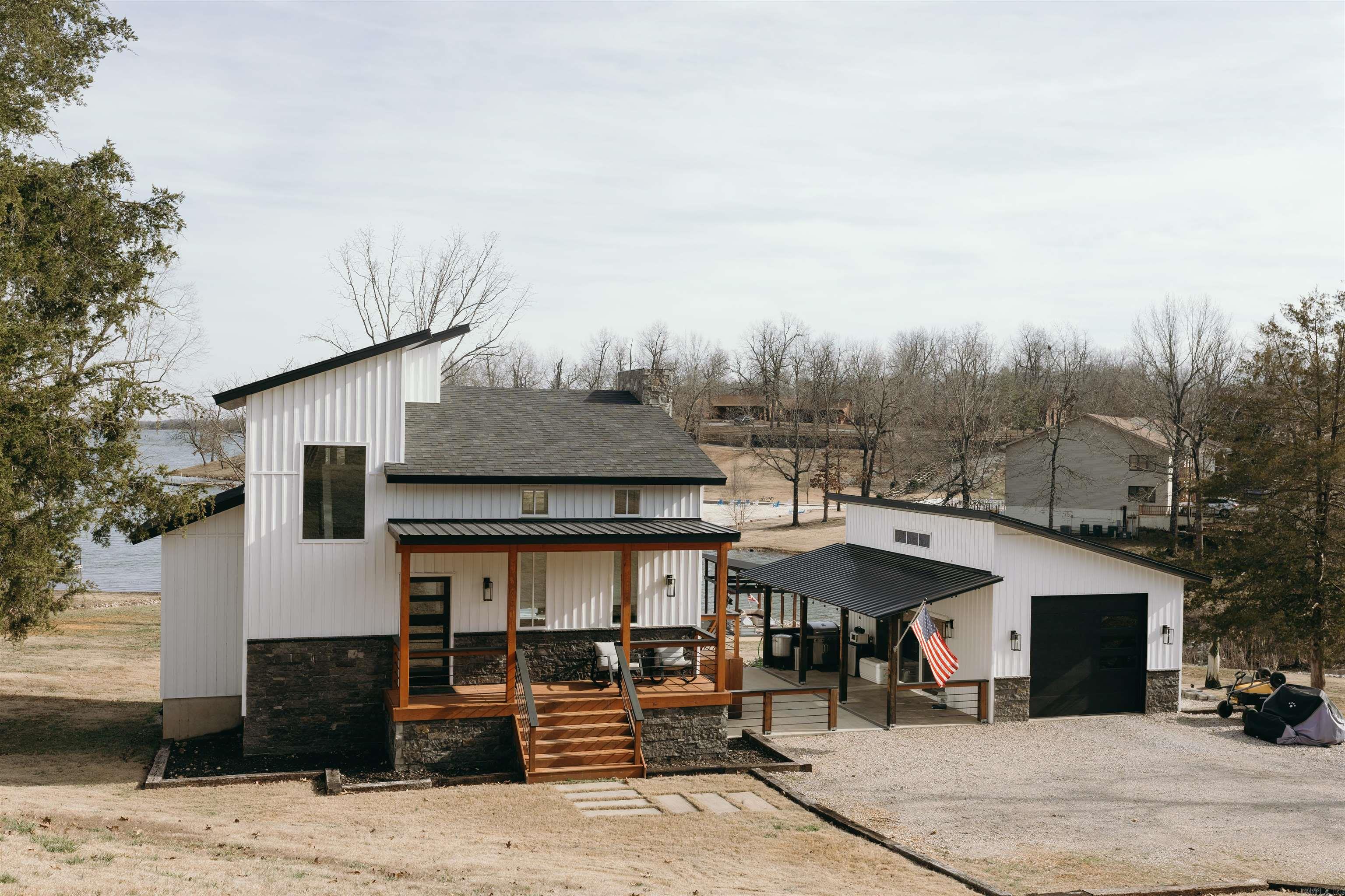 This Home in Horseshoe Bend, Arkansas is a custom built lake home with a modern touch to it. This 2 ½ story home has 3 beds and 3 full baths. The Home was built in 2022 and also has two living areas. The home sits on two lots that make up 1.13 acres. The upscale boat slip is a true highlight. Designed with both functionality and style in mind, it offers easy access for your boat or watercraft, making it effortless to explore the lake whenever you desire. All the amenities that are accessible are mini golf, bar/restaurants, Aqua Park, and more! Interior and exterior items of the home are negotiable. That list is on file.