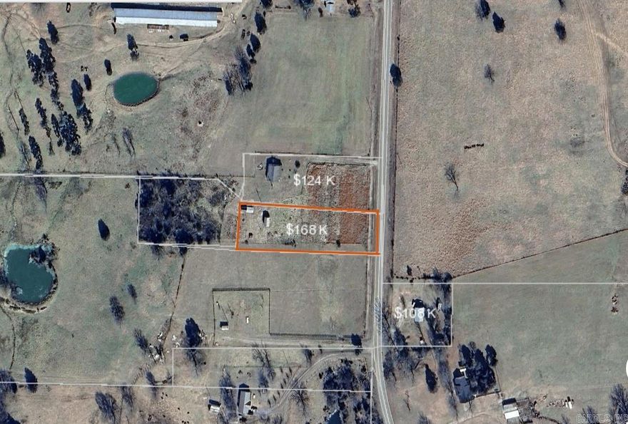 The level 1.3 acre tract is vacant land with paved highway frontage. Approx 130' of road frontage. There is no driveway or structures. Lots of potential here for a home and a little space.