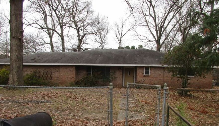 Large brick home with fenced yard.  This home has 3 bedrooms and 2 baths.  Large kitchen, parquet floors, built ins, enclosed back porch, 2 car carport, covered patio.  Call today for your personal tour. Taxes are before Homestead Credit. **Agents See Remarks**