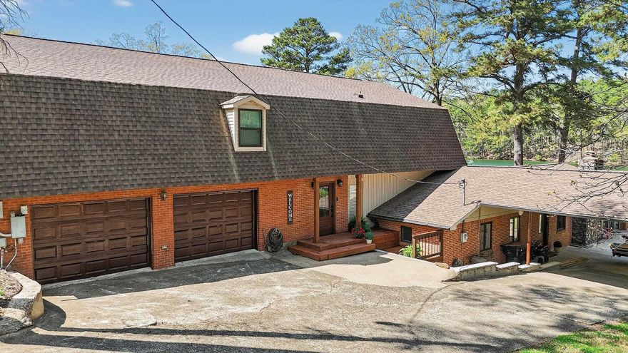 LOCATION! Rare availability in this coveted lake location. GARVAN GARDENS is directly across this large cove off main channel. Within 20 minutes to I-30. 2 stall covered boat dock with swim deck. Rock sitting area lakeside with easy walk out lake access.. Picnic table, palm tree and beautiful landscaping makes for the park like setting. Outdoor kitchen/cabana & RV hookup/parking. PLENTY of room! A split level with major lower level remodel to studs/concrete. Significant updates to the newer, upper level. Roof and all 3 heat pumps replaced in the last 2-3 years. Upper level has a Mstr bdrm with walk-in closet & laundry along with 2 add'l bedrooms each with full bath. Upper also features a kitchenette, dining/office, large den with gas fireplace and large picture windows. Middle level features an XL 2 car garage with a 1/2 bath and workshop. This same level has an XL room that has been used as an add'l bedroom and/or playroom. A few steps down to lower level finds yet another Mstr bdrm with a XL closet, full bath and sunroom. The main kitchen and den with a gas fireplace are on this level along with an add'l laundry, wet bar, XL pantry and XL 1 car carport. IDEAL!