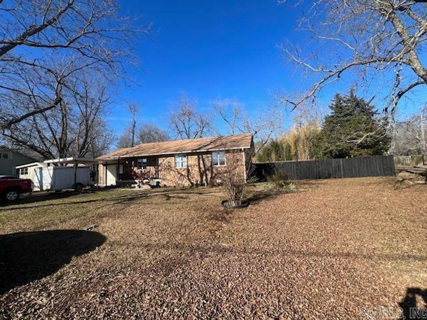 Perfect price! You won't find another one like this on the market, so better move fast!  This brick home has double pane windows, central heat and air, plus three large bedrooms with nice closets. Stained hardwood and tile floors, new paint, plus stainless steel appliances give this home an updated feel with a sense of comfort. Washer, dryer, refrigerator and microwave stay, so all you need is to move in your personal belongings!  Back deck is spacious, allowing you to enjoy the fenced backyard. Property has an abundance of storage including two outbuildings and a workshop/storage space attached to the house. Bad weather? No problem when you have a large above ground storm shelter! Ceiling fans have remotes, and the kitchen light has a remote, a variety of light settings, and a dimmer. The large 90x139 corner lot has access from two streets. See this today before it's gone!  Agents please see remarks.