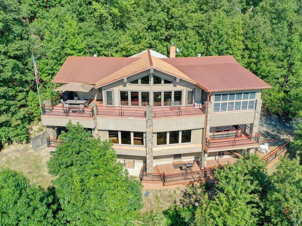 Incredible home with spectacular views! Located in the Mountain Harbor Resort area this home sits on approximately 3 acres and overlooks Lake Ouachita. Features include 4 large bedrooms and 3.5 baths with vaulted ceilings in the open living area overlooking expansive views. Gather in the kitchen that's worthy of any chef then retire to the large master suite and enjoy the stars from the private screened porch. Guest suites on the lower level, game room and gallery decking for wall to wall views!