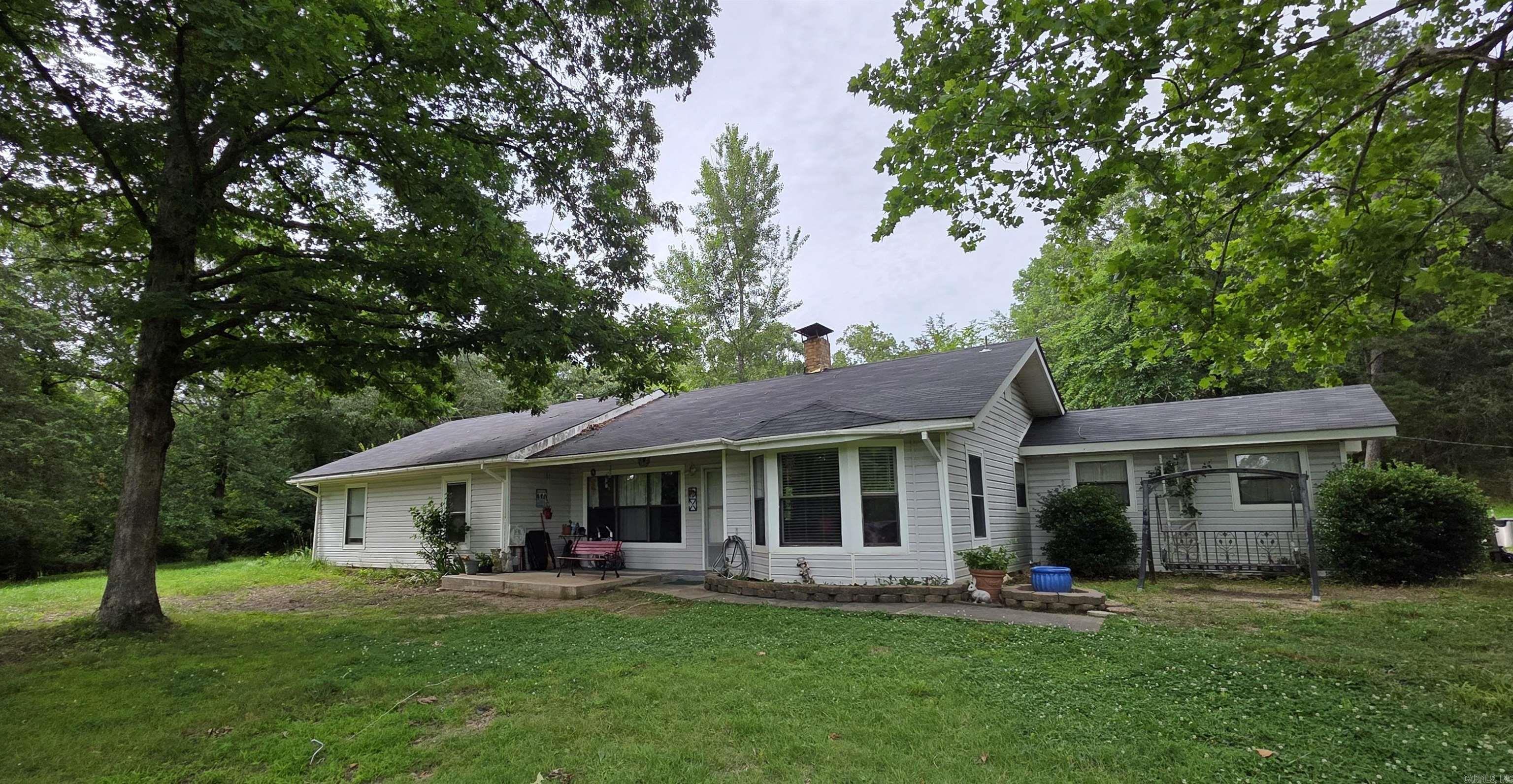 Explore this cozy home situated on nearly 19 acres! There's so much to offer here, including hickory and pecan trees, walnut trees, a pond, a garage with a loft and 220-volt power, as well as a storage shed and a lift. Inside, you'll find a kitchen featuring an entire wall of cabinets and a unique granite-topped island. The home is equipped with a gas range, gas central heating, and a beautiful soapstone wood stove. At the back, thereās a fully set up office and laundry area. The bay window in the front provides excellent views of the wildlife that roam through the property. Schedule an appointment while it's still available!