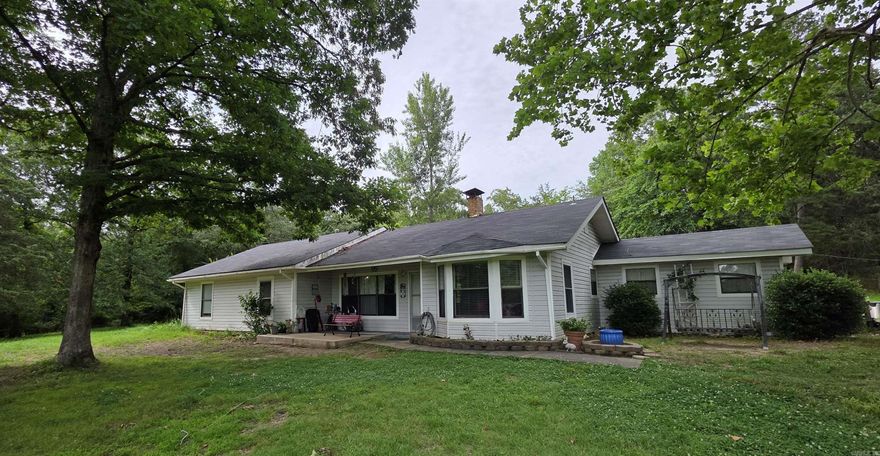 Explore this cozy home situated on nearly 19 acres! There's so much to offer here, including hickory and pecan trees, walnut trees, a pond, a garage with a loft and 220-volt power, as well as a storage shed and a lift. Inside, you'll find a kitchen featuring an entire wall of cabinets and a unique granite-topped island. The home is equipped with a gas range, gas central heating, and a beautiful soapstone wood stove. At the back, there’s a fully set up office and laundry area. The bay window in the front provides excellent views of the wildlife that roam through the property. Schedule an appointment while it's still available!