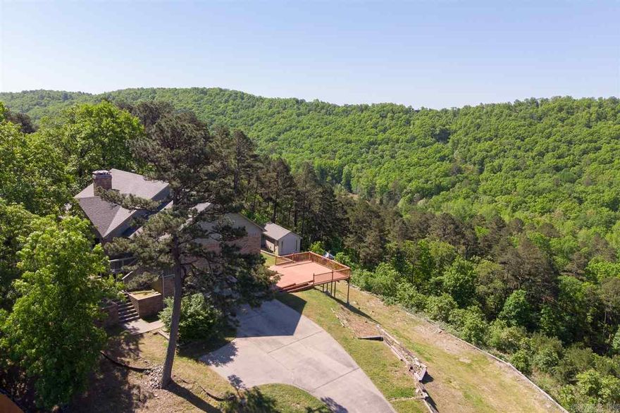 WOW! Mountain retreat close to the city! Newly renovated home sits on 5 acres in small, gated community, only 6 miles from Chenal Pkwy. Open floorplan w/hardwoods throughout. Gorgeous kitchen w/stainless appliance, double oven. Fridge stays! Large master suite w/soaking tub & his/her closets. 2 additional bedrooms & full bath w/tile flooring apart from master. Lower level laundry w/utility sink. Multi-level deck perfect for relaxing & watching the wildlife. Storage building w/electricity. Agents see remarks