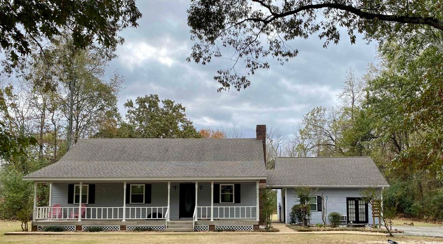On 2 acres!  Just a block outside of city limits on the west side of town, this home has country charm on the outside and a modern look on the inside. Property has a total of 6 bedrooms, and 4.5 baths, 2 pantries, a bonus room and lots of unique extra storage areas. This home is made for a large family. The master bedroom suite features 3 closets, built in drawers, a sitting room/office, and 2 full baths.  Roof, one of the HVAC units, flooring downstairs, and many other things in this home are new in the past 5 years. New siding in progress. Granite Counters in the Laundry room recently added! Guest house is attached by common roof and could easily be enclosed to be part of the home. Agents see remarks.