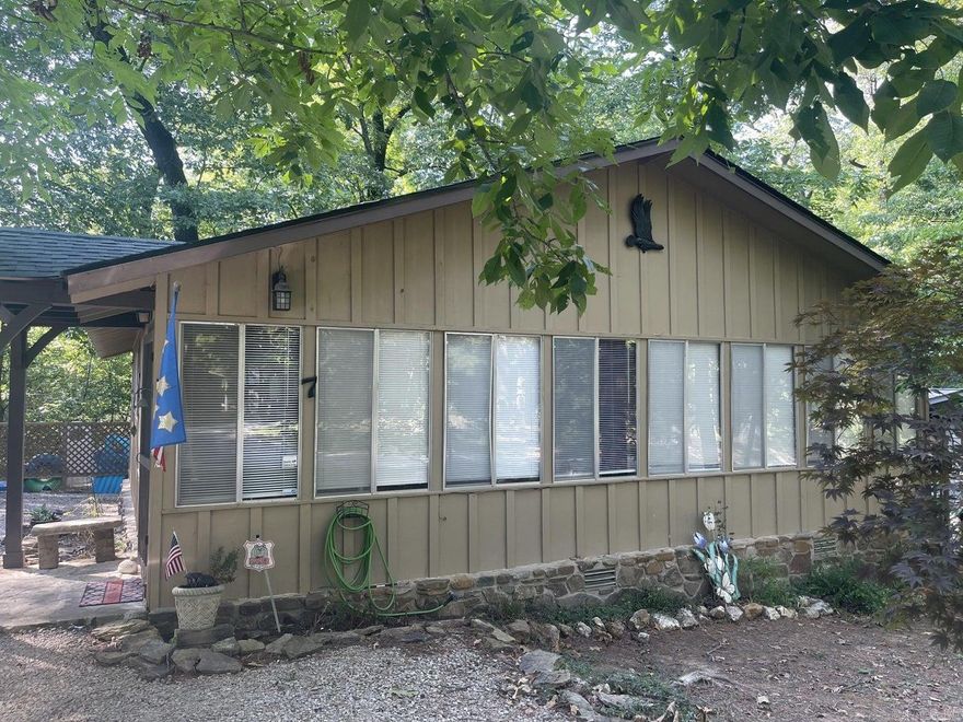 Spring River semi-secluded furnished 2 Bedroom 1 Bath cottage in a private community. Home features wood vaulted ceiling in the large living area, good sized bedrooms and a kitchen with lots of natural light that opens onto the back deck just ready for relaxing or entertaining. The bath is large enough to install a washer and dryer if wanted. There is a community dock with access to the Spring River and Rio Vista Falls. Updates include new hardwood flooring, roof, HVAC, insulation and wiring in the last year. Most furnishings will convey. This would make a great permanent home or a vacation get away!