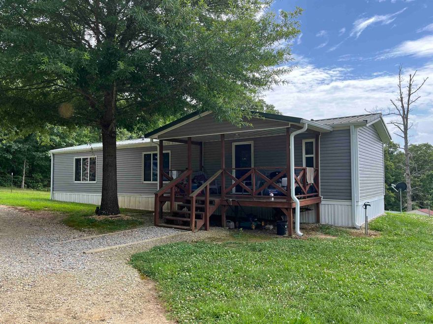 Turn-Key Homestead on 5.5 acres-Fully Furnished and READY TO GO! This fully furnished, custom-built manufactured home sits on 5.5 acres of usable pastureland and is ready for you to move right in and start your homesteading journey. Featuring 2 bedrooms and 2 baths, the home also includes a 12x16 double-insulated unfinished addition that would be perfect for a 3rd bedroom, office, or bonus room. Energy saving windows bring in natural light while keeping utility bills low. Updates include new siding and a durable metal roof in 2014 for peace of mind. The property is fully fenced with 5 strand Red Barb wire and includes everything you need for sustainable living: a barn, corral with head shoot, chicken house, hog pen, small pond, and a garden space ready for planting. Whether you're dreaming of a self-sufficient lifestyle or a peaceful rural retreat, this property has everything already in place. Don't miss your chance to own a move-in-ready mini farm! See Agent Remarks