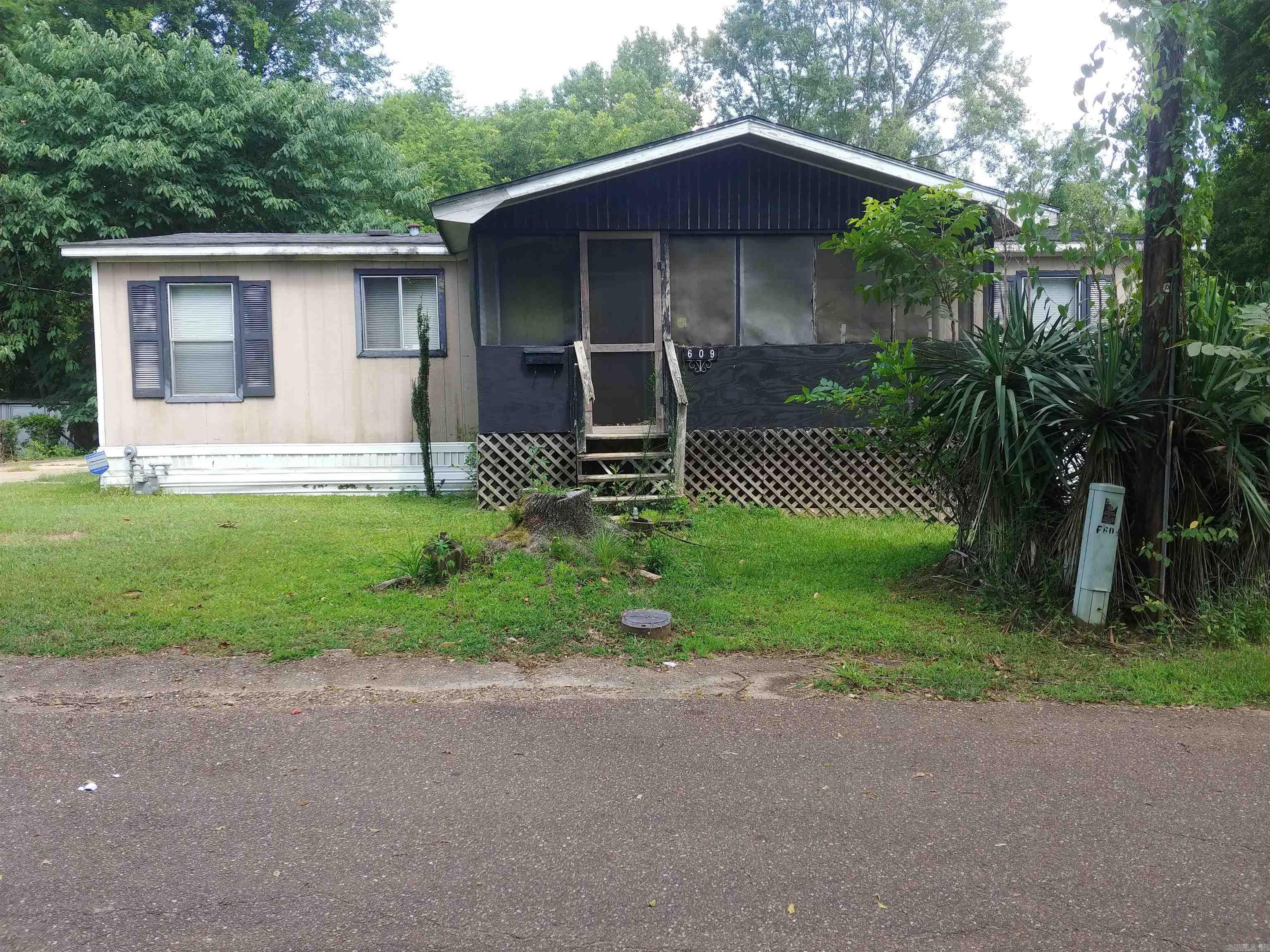 This 3 bedroom, 3 bath manufactured home sits on a quiet lot tucked away in an older neighborhood. The family room area has a gas fireplace and lots of space. All bedrooms are nice size and there is a screened in porch off the family room. The seller is willing to sell the contents of the property if interested. The property is being sold "as is where is" This is a great starter home.