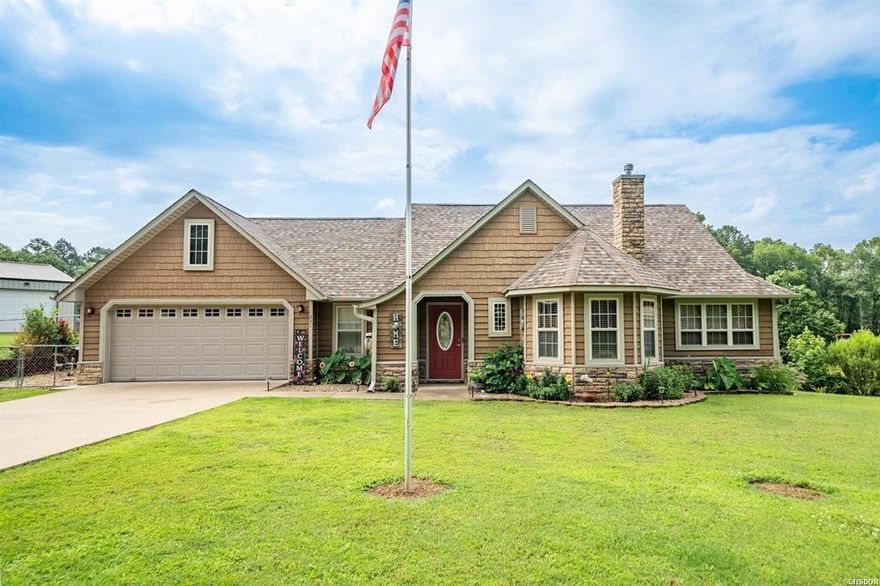 Welcome Home! This stunning 3-bedroom, 2-bathroom Stone and Cedar home offers comfort, convenience, and charm. Immaculate landscaping and natural surroundings provide incredible curb appeal, all just 2.4 miles from Lakeside School. Enjoy cozy winter evenings by the fireplace or unwind year-round in the covered, screened porch. Perfect for entertaining or a quiet morning coffee, this outdoor haven opens to a scenic backyard where deer roam daily and a peaceful pond awaits—ideal for koi or ducks. The spacious master suite features serene pond views, creating a tranquil retreat. The kitchen is equally inviting, offering solid surface countertops, solid wood cabinets, and ample room for cooking and hosting. The home is designed with accessibility in mind, featuring a hall bathroom with a walk-in tub. Additional highlights include an oversized, climate-controlled garage, a 10x12 shed with electricity, a whole house generator, and a backyard storm shelter. USDA Rural Development Loan eligible—schedule your tour today and discover your perfect blend of nature and comfort!