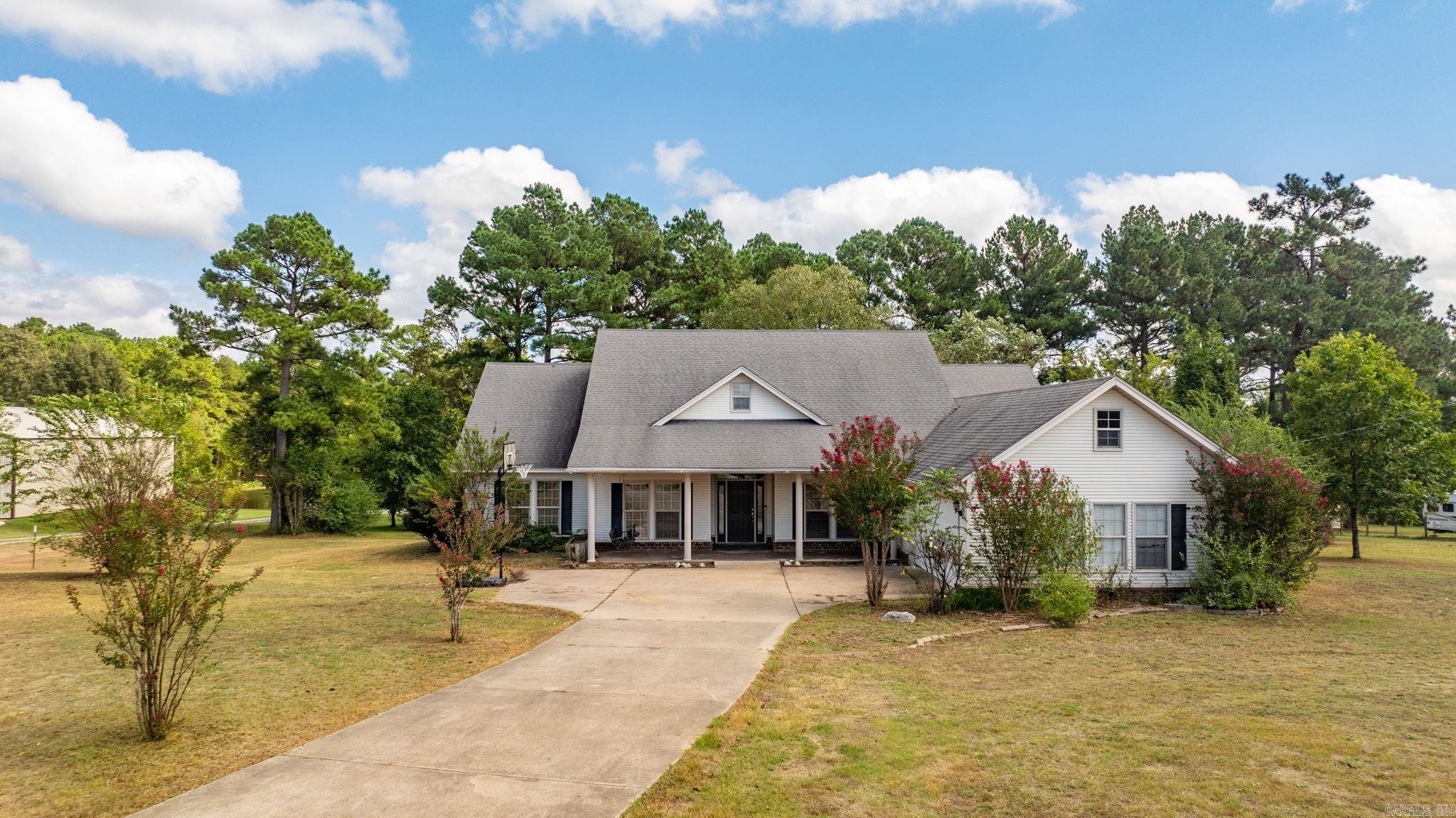 Peaceful, rural living on 1.56 acres! A rare opportunity to own a charming 4 bedroom, 2 1/2 bath country home near Lake Norrell. If you're dreaming of a quiet country retreat just 30 minutes from Little Rock and 15 minutes from Benton, this is it! With a welcoming front porch (and front porch swing!), lots of open space, and plenty of room for gardening, the possibilities are endless! Inside, you'll find an open concept living/dining/kitchen layout with beautiful double tray ceilings and lots of natural light. New luxury vinyl flooring! Granite countertops in the kitchen with plenty of cabinetry and breakfast nook. Large pantry! Generous primary suite with tray ceilings. Primary bath showcases a spa-inspired soaking tub and walk-in closet. 3 separate bedrooms on the opposite side of home share a full bath. This home lives like a one level with a bonus playroom or office space upstairs. Amenities include a laundry room, lovely covered back porch, and 2-car garage with plenty of storage. Enjoy the privacy and serenity of rural living, while still being within easy reach of nearby towns, a lake and other amenities! Lots of country charm! Come see today!
