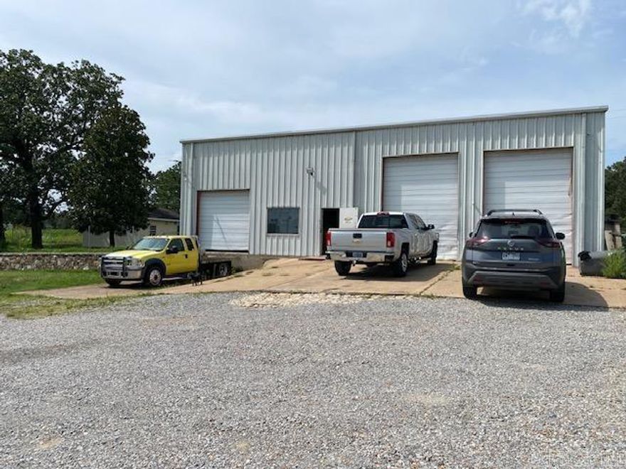 Large shop with highway frontage. This shop has 3,000 sq ft of shop space with a small upstairs apartment. Included are a loading dock and 2 16' overhead electric rollup doors and is wired for 220- 3 phase power. This property has great potential. Included is a 22x22 stoage building separate from the main building for extra storage. Comes with 7 security cameras and monitor. Shop is heated and cooled.