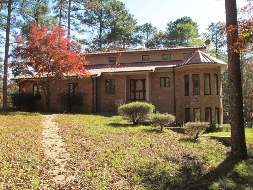 There is nothing like it on the market. A rare opportunity to own a fabulous home adjoining the US Corp. of Engineers land on  61 acres only minutes from the Lower DeGray Lake and boat ramp, Iron Mountain Marina, cabins, boat ramps on Lake DeGray and a very highly regarded bike trail system on Iron Mountain. A custom home with 2 fireplaces, private office, 3 BR, 2 1/2 baths, Brand new custom bathroom with soaking tub and separate stall shower. Double vanity and LOTS of closet space throughout. Towering ceilings in the Great Room with lots of glass to enjoy the wooded view of outside. Huge covered deck overlooking the fish pond and lots and lots of trees. No other house in sight of this one. The Seller is offering a $10K flooring allowance. Double garage and an additional carport on an adjacent area with utilities and septic for another shop or 2nd. home. The list goes on and on!!!