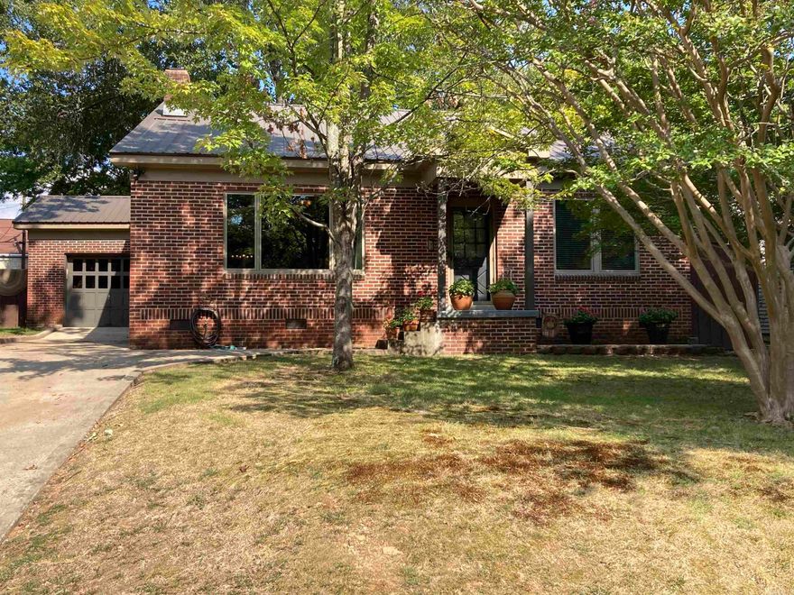 Situated on one of Park Hill's favorite streets, this all brick home has lots of modern updates, plus it oozes with period charm... 9' ceilings, original hardwood flooring, built-ins & more. Large, open living to dining to kitchen layout features large windows and fireplace w/ mantel-piece along library paneled wall. Kitchen w/ quartz counters, tiled backsplashes, stainless appliances, & painted, custom cabinetry w/ built-in pantry. Bright sunroom, office or extra living area/ den. Laundry nook off kitchen. Large master w/ his and her closets. Spacious bath features original floor tile, subway tiled tub/ wainscoting and updated vanity/ fixtures. Attached garage. Updated replacement Pella brand windows, metal roof, and tankless water heater. River rock lined 19X29 stained concrete patio in shaded, custom 8' privacy fenced backyard. Seller is offering a First American Home Warranty to Buyer.