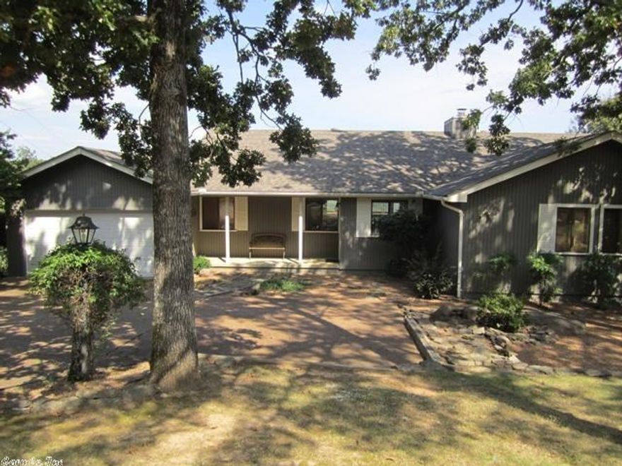 Enjoy the lake view and sun rise from the sun room or the spacious deck in this updated home that is close to all the amenities Fairfield Bay has to offer.  There are 3 bedrooms and 2 baths on the main level.  A fourth bedroom and bath is down stairs along with a large game room and a wet bar.  The patio downstairs also has a lake view.  This lovely home has room to spare for a large family or guests.  You cannot find a more attractive home with the view for the price.  RV parking at the rear of house.