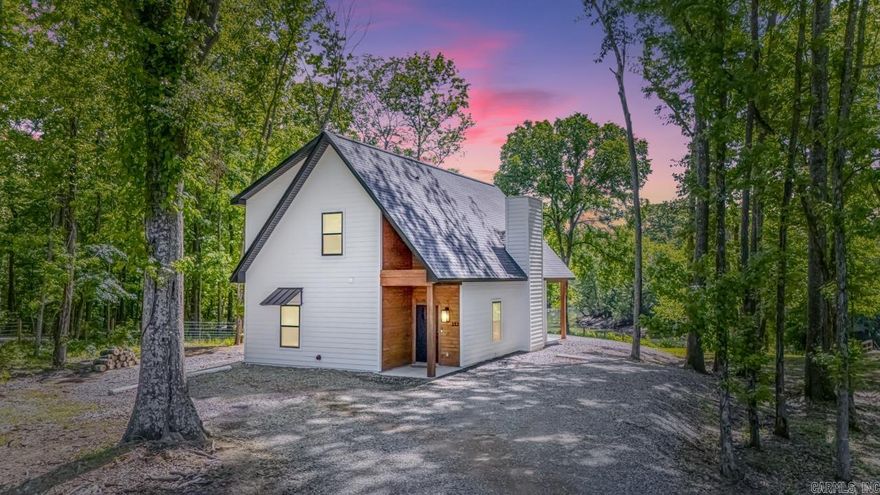 Welcome to The Ivory, a stunning new luxury cottage on 1.5+ acres along the sought-after Little Red River. Whether you're searching for a private retreat, vacation home, or short-term rental opportunity, this fully furnished river-view home is ready to impress. Inside, the open floor plan features vaulted ceilings, a cozy stone fireplace, and a chef's kitchen with quartz countertops, tile backsplash, stainless steel appliances, and a large island made for gathering. The main-level primary suite offers a walk-in closet and custom tile shower. Upstairs includes a spacious guest bedroom, full bath, and versatile loft with a closet that works well as a bunk room, playroom, or added guest space. Outside, enjoy the oversized vaulted back porch with peaceful river views, or take just a few steps to the brand-new shared dock. Sold fully furnished with decor and essentials included, The Ivory is turnkey and ready for full-time living, a weekend escape, or vacation rental use. Minutes from town and just over an hour from Little Rock.