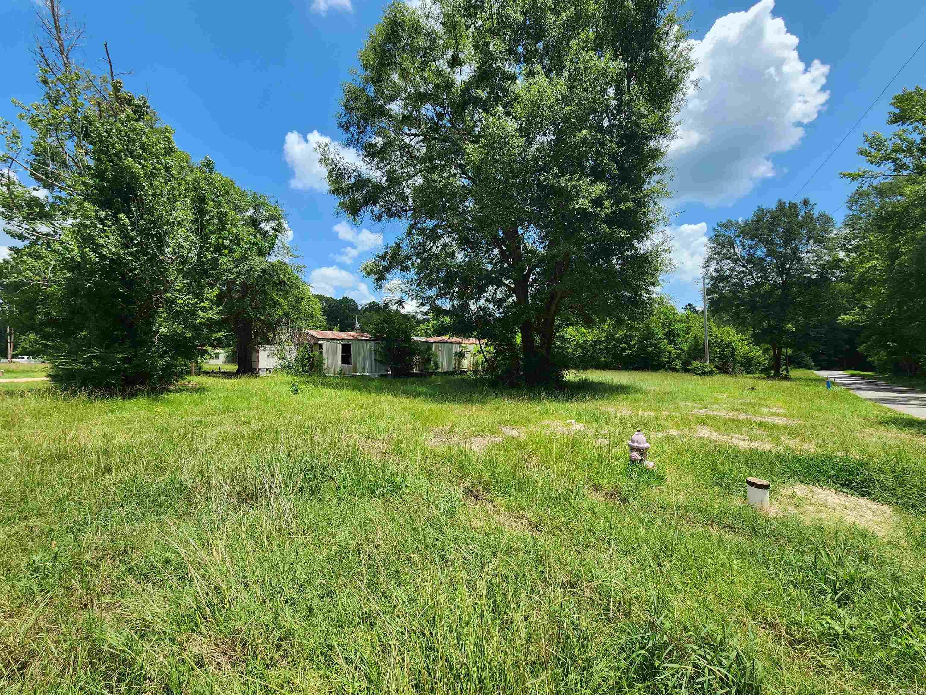 Great Investor Opportunity! This 6.16 acre tract of land in Junction City AR has the potential to be used as 12 mobile home lots OR divided how you choose! This site is fairly flat and has full utility access with electrical poles set at regular center intervals on the property. Currently there are two lots rented at $125/lot. *Please note: There is no current survey for this property and no occupied mobile homes will transfer with this sale. This listing is land only.