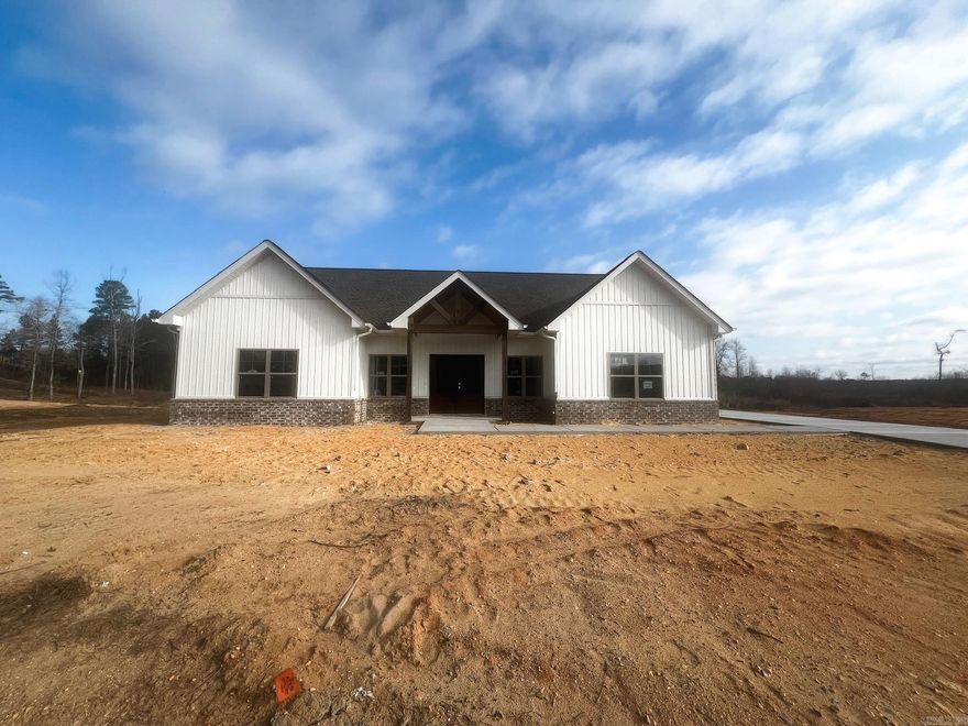 Welcome to Winchester Estates - a new construction neighborhood with 1 acre+ lots in the Bauxite School District. This home has beautiful curb appeal with a double stained front door, vaulted peaks & side load garage. Enter into the open floor plan living room & kitchen with a HUGE island, quartz countertops and tons of cabinet space. The living room has tall ceilings, an electric fireplace and beautiful LVP flooring. The primary suite is tucked away with tray ceilings, double vanities, soaker tub, walk in shower & a generous walk in closet with built in dressers and storage. You'll find 3 additional bedrooms and a total of 2.5 bathrooms. All situated on a 1.28 acre lot. Schedule your showing today!