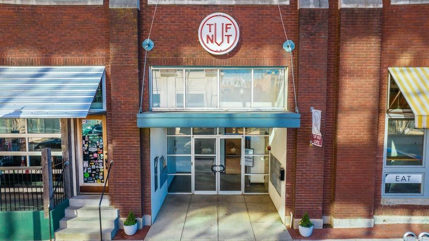 Step into authentic industrial design in this rare studio-style loft, located in the iconic Tuf Nut Lofts. This converted factory space perfectly blends raw, industrial architecture with modern convenience, offering a one-of-a-kind living experience in the heart of downtown. Inside, you'll find true loft character: exposed brick walls, polished concrete floors, expansive windows, and soaring ceilings that create a sense of space and style. The open layout includes a full kitchen and bathroom, along with separate bedroom area for optimal space and function. Updated stainless appliances and granite countertops. Enjoy secure, controlled building access and the option for garage parking. Pet-friendly. Just steps away from the River Market District, Arkansas River Trail, top-rated restaurants, vibrant nightlife, art galleries and parks. Whether you're looking for a stylish downtown residence or a unique investment opportunity, this loft is a rare gem that blends history, location, and urban lifestyle. Agents, please see remarks.