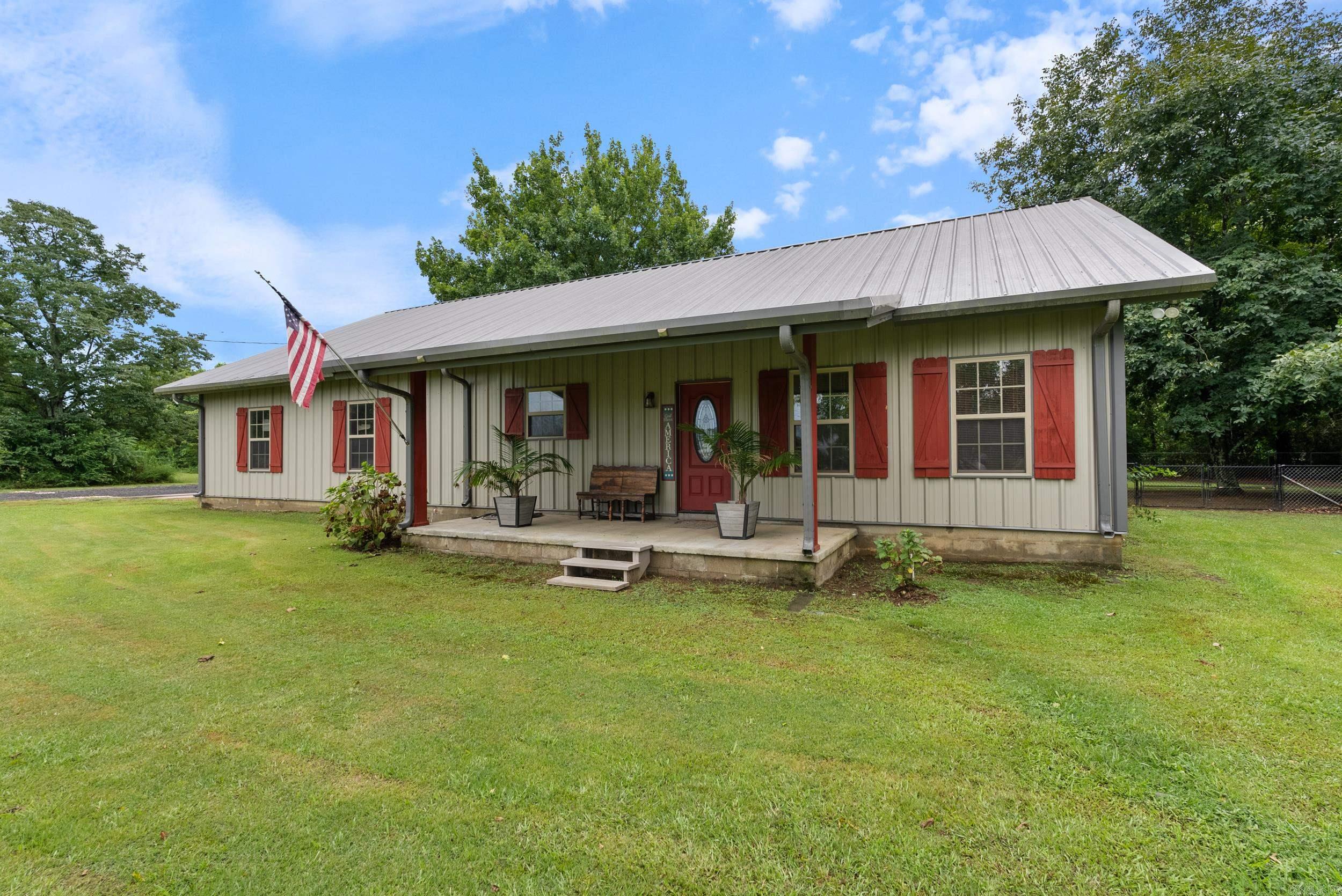 Looking for a peaceful area to spread out? This charming country home sits on .84 acres and features a covered porch, perfect for morning coffee. Inside, you'll find a cozy layout with a vaulted ceiling that adds a touch of character. Also included are 4 bedrooms, 2.5 baths. The fourth bedroom and half bath is through the garage for extra privacy and could also double as an office. The home also has metal roof and siding for durability and low maintenance. Need space for hobbies or storage? You're going to love the 20x40 shop! Located right next door to Vilonia Primary School for convenience in a beautiful rural setting. Whether you're raising a garden, or looking to just get out of town, this one checks all the boxes. Oak cabinets, cherry island, chain link fence, and two large pecan trees! Don't miss your chance to own a piece of the country! Agents see remarks