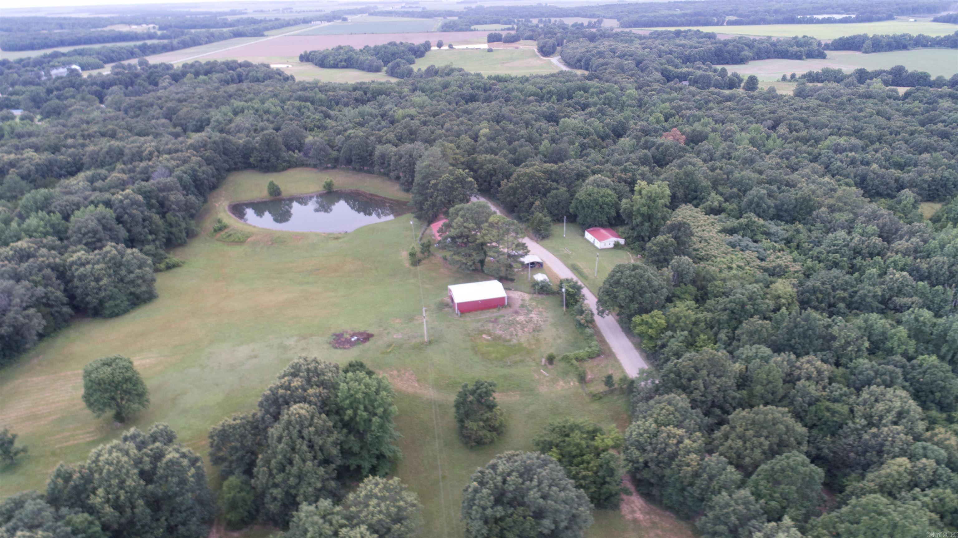 232 County Road 440, Piggott, AR 72454 This stunning property has it all – space, privacy, and endless possibilities. Featuring a 3-bedroom, 2-bath home with a bonus room, this residence is perfect for comfortable country living. Step outside to your 6-foot private fenced backyard, ideal for pets or play. The real gem, 52 acres of fully fenced land complete with two ponds, a 30x40 utility building, and a 36x48 barn with horse stalls—perfect for livestock, storage, or hobbies. There’s also a 12x24 storage building and an additional structure on the property that could be updated for guest housing, a rental, or in-law quarters. Whether you’re looking for a hobby farm, equestrian setup, or private homestead, this property offers the flexibility and freedom to make it your own. Don’t miss this rare opportunity—call today to schedule your private showing! Listed with Forrest Realty | Contact: Theresa Van Barkenhuizen – 870-324-3331