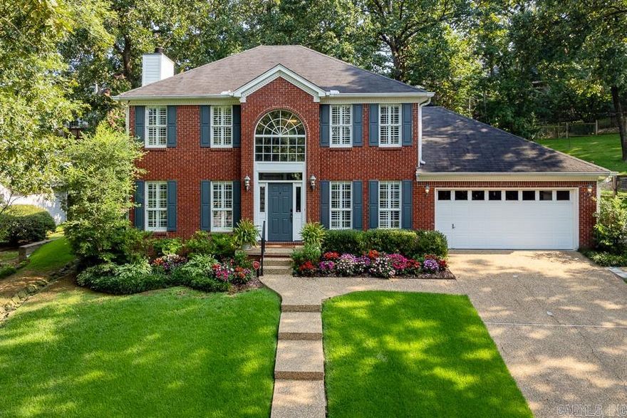 Wonderfully maintained and gorgeously landscaped, this house is lovely both inside and out. Spacious living area with gas log fireplace and French doors that open to stone patio with fully fenced and beautifully terraced backyard. Wood floors throughout living area, formal dining, and bedrooms. Updated eat in kitchen with center island cooktop, breakfast bar, stainless steel appliances and large picture window. Primary suite on main level with elegant bath and large closet. Upstairs features big guest bedroom with access to updated hall bath as well as two more nice sized bedrooms. Two car garage. Great location. Don Roberts school. Lots of storage!  Come See!