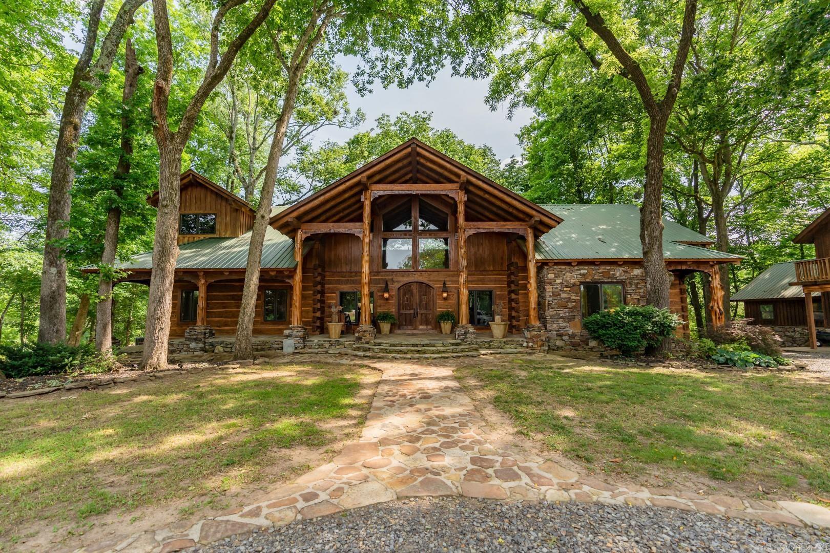 Spectacular Little Red River home on 2 river lots! This 5-bedroom 3.5 bath home has options for more bedrooms if needed! Made from very high-end log construction, this home includes a massive main living area with 2-story ceilings, a large dry-stack stone fireplace, exposed logs and beams, wood floors, multiple balcony and living areas, luxurious kitchen with granite tops, tile floors, 8-burner Viking cook-top, spacious breakfast bar, cozy office, incredible master suite with private loft, large boat dock with huge fishing platform, firepit, basement-area kitchenette, downstairs fireplace, wine room, garage storage, covered parking with apartment above, massive covered deck overlooking the river, easy walk to the dock, metal roof, stone patios and much, much more! A lovely, well-cared-for home!