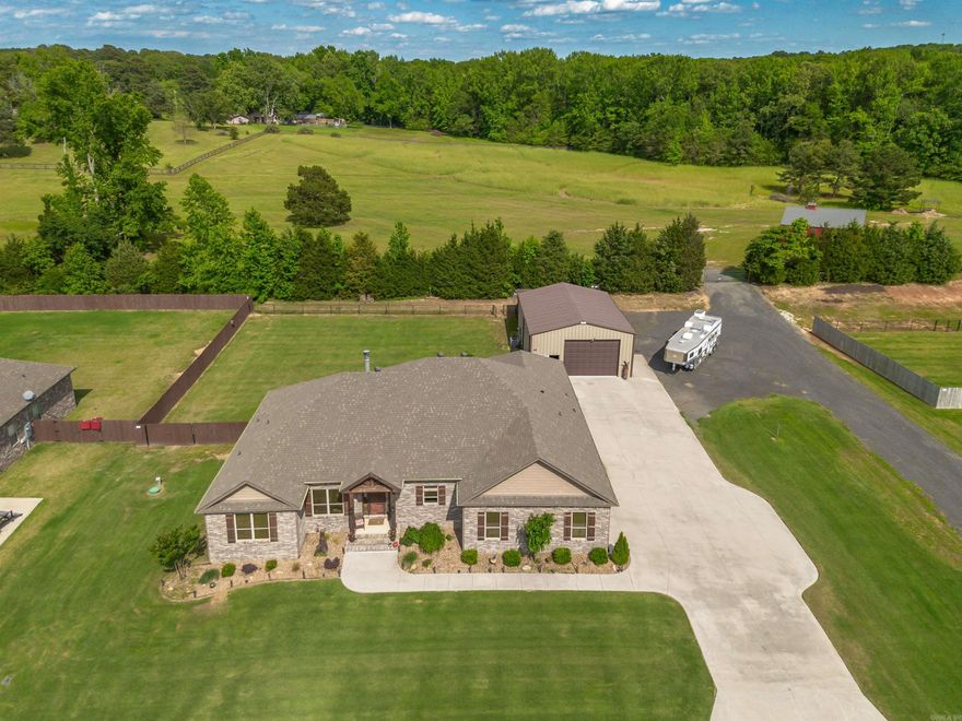 BEAUTIFUL custom home built by Larry Weathers with no expense spared! This home has it ALL! Classy, western style, home with potential to keep horses on the neighboring property! This 3 Bedroom, 3.5 Bath home + Office includes an insulated 30 X 40' Red Iron Shop, complete with heat/air, water & MORE! Cooks will love the gourmet Chef's Kitchen loaded with solid, wood cabinets, stunning granite countertops, walk in pantry and a breakfast bar! Great Room features a stone, wood burning fireplace! Wood ceiling in the Primary adds richness & warmth to the spacious room. All Bedrooms have En-Suites; Primary showcases a rustic styled shower with double showerheads, vanity & generous closet space. Large Laundry Room has built in sink and tons of storage. Six person Storm Shelter included! Extended Garage accommodates trucks and more! Covered patio offers the perfect space for outdoor entertainment! This is a stunning, immaculate home! You must see!  Agent Remarks.