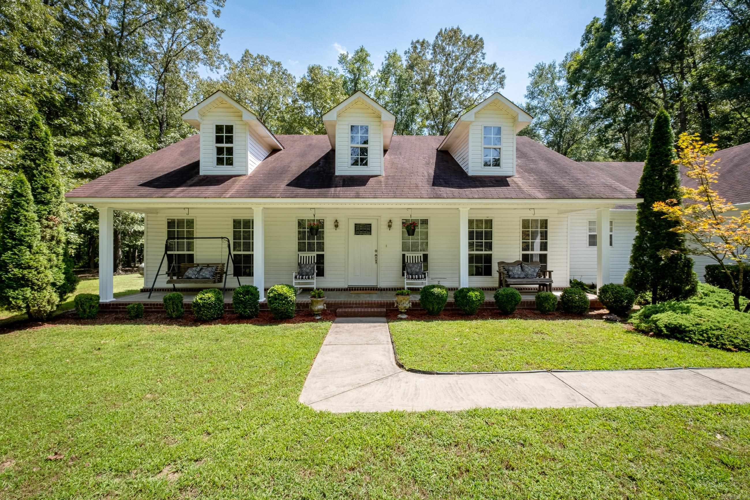 Peaceful, country living just 20 minutes from downtown LR! This lovely, traditional one-level home rests on approximately 5 wooded, mostly flat acres. The 3 living spaces are quaint and quiet. The main living room boasts vaulted ceilings with a breakfast bar opening to a spacious kitchen with updated Kenmore appliances. Hallway leads to a generous primary suite with a sizeable walk-in closet. 2 more bedrooms opposite with a shared full-size hall bath. Spacious laundry/pantry. Sunporch added, along with a garage that was made into an oversize game/family room for extra space! 20x40 storage/garage detached. White Hall schools. Fantastic opportunity for land and a move-in ready home in the beautiful Cherrywood Estates subdivision! AGENTS: See showing remarks.