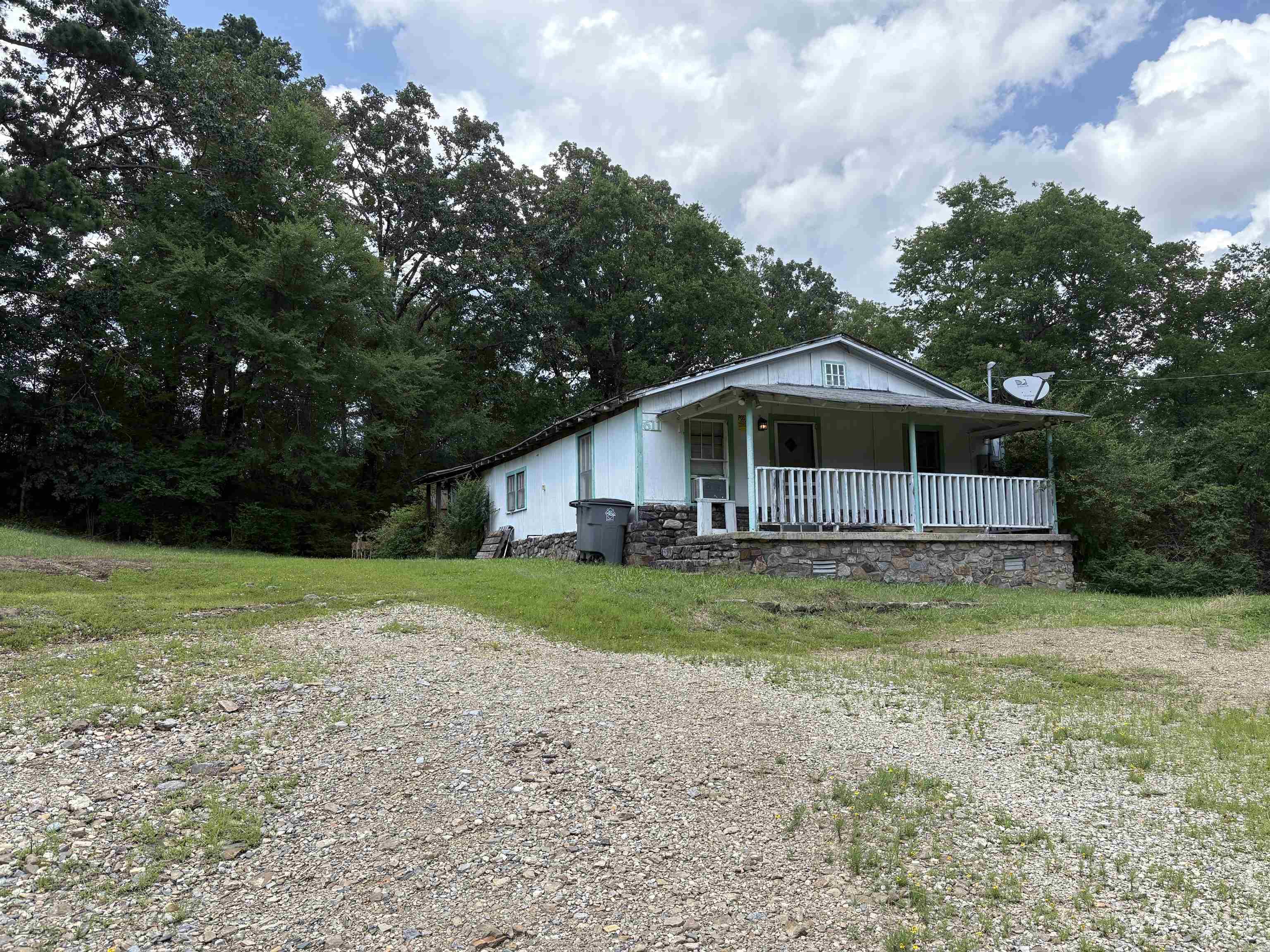 Welcome to 611 Lakeside Rd, where opportunity meets location. This home is being sold as-is! Whether you're looking to renovate, expand, or build your dream home from the ground up, the possibilities are endless. Surrounded by trees and set back from the road, the property provides a peaceful retreat while still being conveniently located near everything Hot Springs has to offer. Mature trees, natural beauty, and endless options await for you to make it yours.