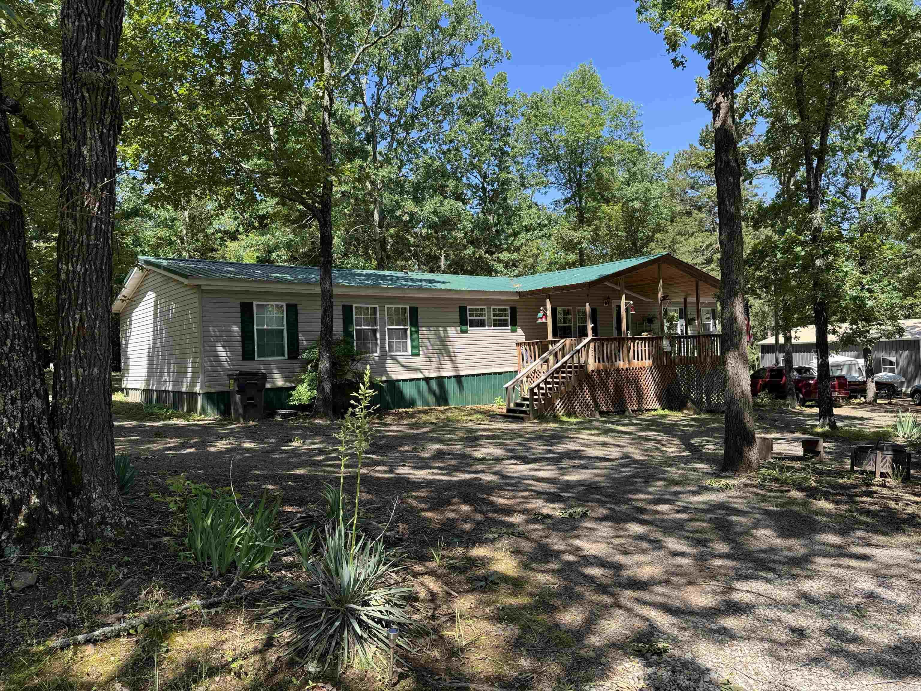Looking for a spacious house for all the family and friends? This home has it plus your in walking distance to the lake located at the end of this road. This is a 5 bedroom 2 bath with a bonus room off of the living room for an office or a quiet little space for reading. With new carpet, new wood on the porch ceilings, wood burning fire place, newly cleared trees from back yard , new septic system and furnishings are negotiable so come see this before its gone. Call today this wont last long !!!