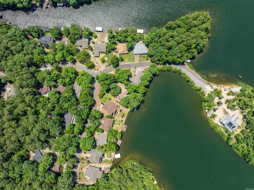 LAKE CORTEZ SHORELINE LIVING WITH A PICTURE-PERFECT VIEW OF THE WATER FROM ALMOST EVERY ROOM! Beautifully updated home of quality-sound construction that was built by an engineer for his own retirement. Stunning views greet you the moment you open the door! The expansive living area is bathed in sunlight. The first thing you will want to do is cozy up to one of two fireplaces or enjoy the deck's solitude and panoramic view for morning coffee and evening sunsets. The spacious open areas allow you to flow from one area to the next and make entertaining in this home a breeze both inside & outside!  Upstairs & Downstairs living provide privacy. Upstairs has not one but two relaxing primary ensuites featuring spa-inspired bathrooms. The office with lake view makes work & study time more enjoyable or could be fourth bedroom or exercise area. The downstairs snack kitchen & fireplace create a perfect living space for enjoying family time. There is also a workshop/hobby room for tinkering. Pleasing lake life with approximately 80' of sea wall, a boat slip, & stairs to lake provide easy access for boating, swimming, fishing, or kayaking. 1 year warranty included!  AGENTS SEE REMARKS