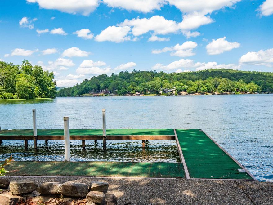 LAKE CORTEZ SHORELINE LIVING WITH A PICTURE-PERFECT VIEW OF THE WATER FROM ALMOST EVERY ROOM! Beautifully updated home of quality-sound construction that was built by an engineer for his own retirement. Stunning views greet you the moment you open the door! The expansive living area is bathed in sunlight. The first thing you will want to do is cozy up to one of two fireplaces or enjoy the deck's solitude and panoramic view for morning coffee and evening sunsets. The spacious open areas allow you to flow from one area to the next and make entertaining in this home a breeze both inside & outside!  Upstairs & Downstairs living provide privacy. Upstairs has not one but two relaxing primary ensuites featuring spa-inspired bathrooms. The office with lake view makes work & study time more enjoyable or could be fourth bedroom or exercise area. The downstairs snack kitchen & fireplace create a perfect living space for enjoying family time. There is also a workshop/hobby room for tinkering. Pleasing lake life with approximately 80' of sea wall, a boat slip, & stairs to lake provide easy access for boating, swimming, fishing, or kayaking. 1 year warranty included!  AGENTS SEE REMARKS