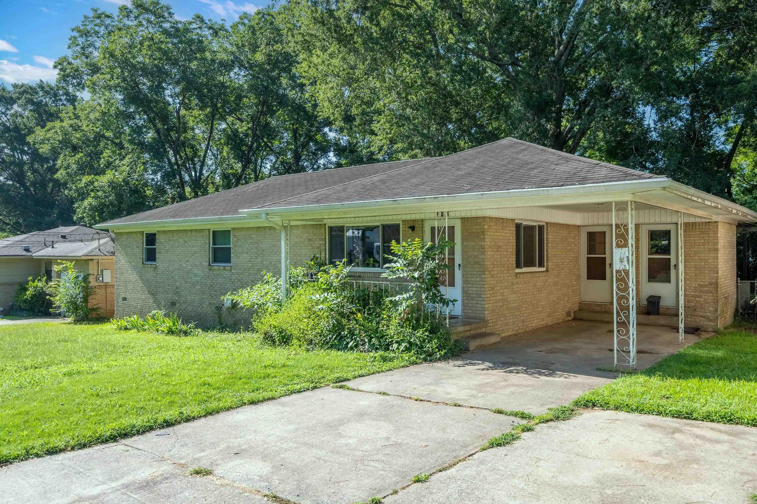 Welcome to 210 W. 52nd! This home offers hardwood floors, plenty of space, 3 bedrooms, and 1.5 bathrooms. There's a comfortable den and a living room with good windows for natural light. Kitchen is generously sized with a separate dining area great for meals or gatherings. Outside, enjoy a large fenced backyard and a covered porch. Schedule your showings today! Agents See Remarks