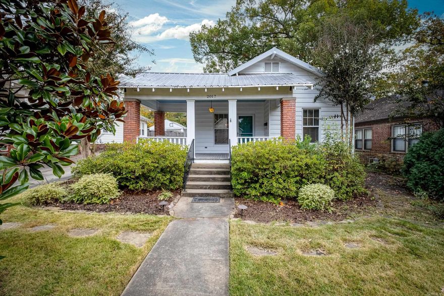 Beautifully updated 2 bed/1 bath bungalow featuring a wraparound front porch, gorgeous hardwood flooring, updated kitchen with breakfast bar and covered back porch. Conveniently located within walking distance of all the retail/dining options in the Heights area. Bathroom was remodeled in 2018 with new soaker tub, tile, vanity and lighting. Oversized one-car garage was completely renovated with new siding, drywall, insulation, paint and electrical, and has plenty of space that could be used as a shop or additional storage.  Numerous exterior improvements include extensive custom landscaping, new sprinkler system and more! New A/C installed in 2022.