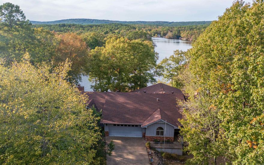 Waterfront with 2 Car Garage, Dock w/Hoist and Panoramic View! This one-level, open-concept townhome provides low maintenance waterfront living with a hard to find 2 Car Garage! 6 Panel Doors, Granite Counters, Tray Ceiling in Primary Bedroom, Generac backup propane generator! Large, Insulated, Shop/Storage Area under Main Level. New highway bypass allows quick access to Hot Springs through the Glazy Peau Gate! Lake Pineda is 62 acres with great fishing (motors allowed - 20 mph). Hot Springs Village is a gated 26,000 acres with 11 Lakes & 9 Golf Courses! Enjoy Miles of Walking Trails, Indoor and Outdoor Pools, Tennis, Pickleball, Bocce Ball, Miniature Golf, Fitness Center, Performing Arts Center,2 Marinas, a Dog Park and much more!