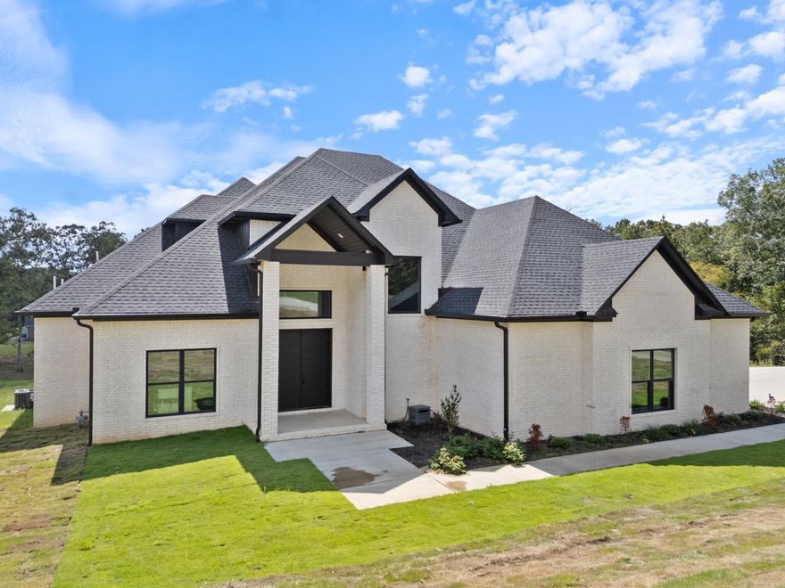Built in 2023, this contemporary home, on 2.54 acres within Conway city limits, complete with Conway Corp utilities is a must see. You'll love the 22-foot ceiling, natural light, and marble floors in this 5-bedroom, 4.5-bath home. Located just minutes from the interstate, this house is located in Northwoods Estates, a gated community with only 12 lots. The spacious downstairs master suite features a soaking tub, double vanity, walk-in rain shower, and his-and-hers custom closets. Two additional downstairs bedrooms each have their own private full baths. A unique guest/in-law suite is accessible via a private staircase off the garage, leading to a large bonus room, bedroom, full bath, and office, perfect for guests or multigenerational living. The kitchen includes stainless steel appliances, double ovens, a wine fridge, a walk-in pantry. The laundry room has tons of storage & sink for added convenience. Step outside to enjoy the expansive covered back porch. This one-of-a-kind property is a rare find in the heart of Conway.