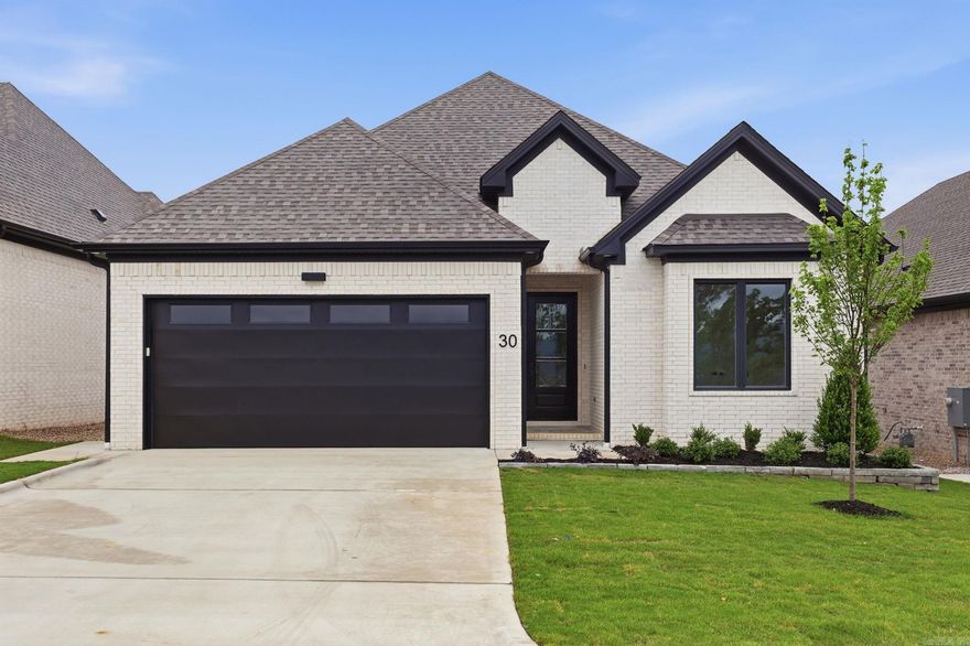Discover Mountain Brook, West Little Rock’s newest neighborhood, ideally situated off Highway 10 behind The Ranch. This single-level Ranch home blends quality craftsmanship with modern style, offering four bedrooms and three bathrooms. The primary suite is a true retreat, featuring a spa-inspired bath with a soaking tub, walk-in shower, and a custom-designed closet. The living room impresses with soaring 12-foot ceilings and a stunning floor-to-ceiling tiled fireplace. At the center of the home, the chef’s kitchen showcases quartz countertops, custom cabinetry, dining area with coffee bar, and a corner pantry—perfect for both everyday living and entertaining. Step outside to enjoy relaxing evenings by the outdoor fireplace. Contact the listing agent today to schedule your private tour..