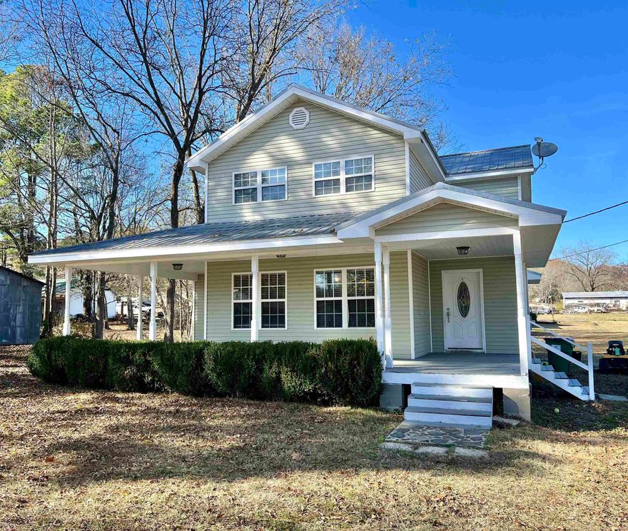 Spacious 4BR/2BA, 2060 sq ft home, built in 2007, on a 1/2 acre, corner lot in town. Convenient to the medical center, grocery store, post office and park, as well as just a few minutes to several Little Red River access points. This two-story, stylish house has a charming wrap-around porch, ideal for a front porch swing or plenty of space for outdoor furniture. Downstairs offers the primary bedroom with adjoining office space and/or additional storage, while upstairs hosts three spacious bedrooms and a full bath. The separate laundry room is a generous size with an industrial style sink, this room would make a great area to add shelving for extra pantry storage as well. The metal roof adds durability to this welcoming residence, providing a perfect blend of comfort and style. Check it out!