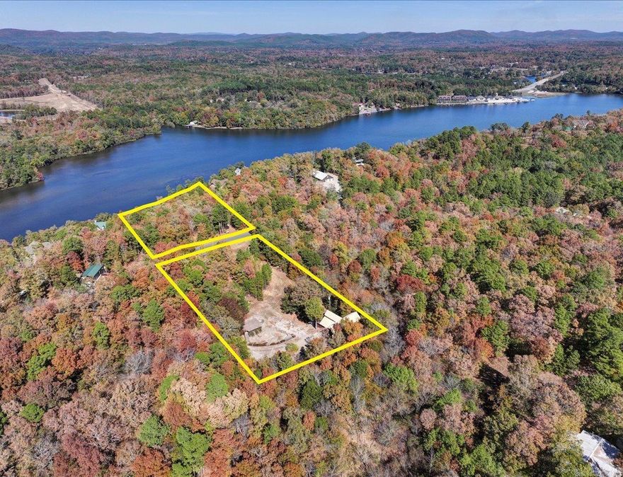 This property is split into two main sections by Woodview Lane, which runs through the middle.  The Northern half of the lot borders Lake Hamilton with 213 front feet of shoreline, offering scenic views and access to the water.  This part could be ideal for a new home site (there's a 1,000 Gallon Septic tank already in place), a private 2 stall boat dock can be permitted through Entergy and much more.  This side also has a 560 sq ft metal storage building in place closer to the road.  On the Southern half of the lot, separated from the waterfront by Woodview Lane, sits the home which is surrounded by a wrought iron fence and secured with a gated entrance. Although this half doesn't have a lake view, it has the makings of a beautiful water feature. The Tiki Hut creates an ideal spot for outdoor gatherings or relaxation.  This section offers privacy and a resort-like feel, perfect for enjoying outdoor activities away from the lakefront.  There's a wooden storage building (100 sq ft) and boat storage already on the property.  Both sides of this lot offer unique potential for extra home sites and more.