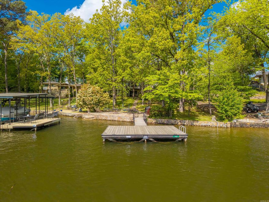 Just in Time for Summer!  Offered for the 1st time, this Lake Hamilton home is located in a Quiet Cove just off the Main Channel.  You will love the Convenience by Water & Land and the Neighborhood is Lovely!  Move in and Enjoy the Nostalgic Interior, or Bring your Vision and Renovate as Desired... The Main Level features 2 Living Spaces, a Central Kitchen, 2 Bedrooms and 2 Bathrooms (the formal living space would make a great 3rd bedroom).  The Lower Level is Completely Separate and offers 2 Bedrooms, 1 Full Bathroom, a Kitchen, Living and Dining Space.  The Views are Quite Nice and the Cove is wonderful for Swimming, Kayaking, and Paddle Boarding.  Call Today for a Tour!
