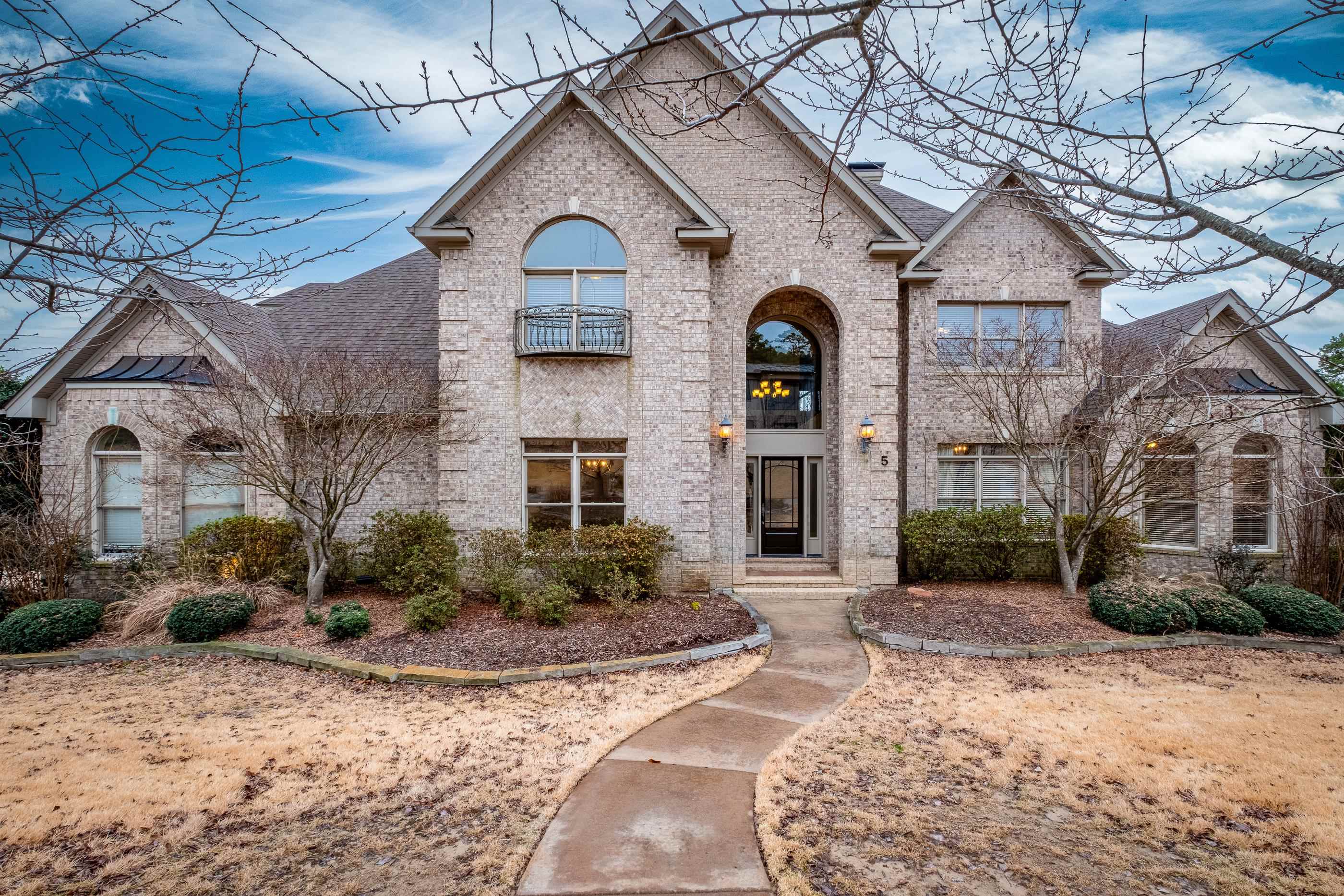 Welcome to the exclusive gated Deauville neighborhood. This 5 bed/4.5 bath home is nestled on a corner lot with three-car side-loading garage, flexible living space w/ tons of storage, refinished hardwood floors, front & back staircases & large yard blends luxury & convenience. Main level has primary suite & separate guest wing w/ en-suite bath, sep office, formal dining rm, breakfast bar & nook, half bath, laundry & large flex space can be another living area/sunroom. Kitchen has large island, double ovens, gas range, built-in microwave & walk-in pantry. Primary suite has access to deck & windows for natural light, and double vanities, walk-in shower, jacuzzi tub & two walk-in closet spaces in bathrm. Upstairs are 3 bedrms w/ walk-in closets, 2 full bathrms, oversized gameroom & media room w/ theater seating, projection screen & dual flatscreens. Expansive deck offers covered/uncovered space overlooks backyard making entertaining easy. Walk-in crawlspace for additional storage. Whole-home generator, epoxy finish on garage floor, built-in cabinets for storage & workshop. Refrigerator, washer/dryer, window treatments, mounted TVs, fire pit table gas grill stay. Roof '16/WH '21.