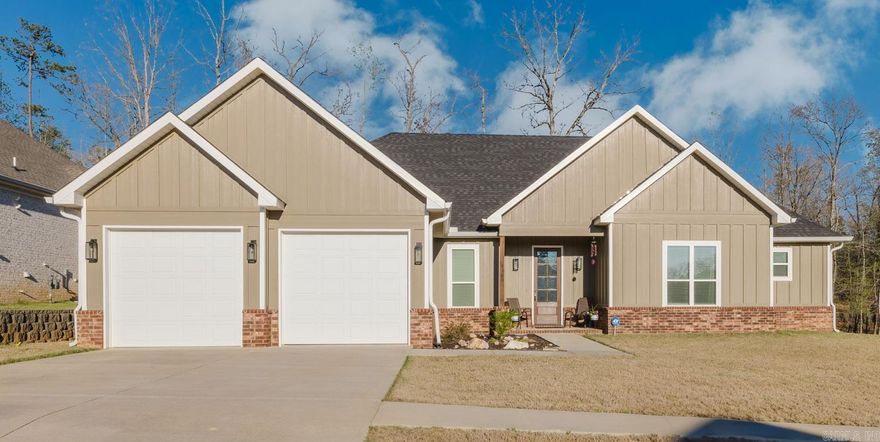 Welcome to this charming home with a thoughtful design and beautiful finishes. The living room is open to the kitchen and perfect for entertaining. Numerous windows provide natural lighting and appeal. The fireplace is perfect for cozy nights at home. The kitchen has plenty of cabinet storage as well as a built-in writing nook, pantry, modern backsplash, and stainless finishes. The breakfast bar and extended dining area make hosting dinners a breeze. The beautiful wood floors of the main living areas extend into the spacious primary suite. There you will find a spa retreat with a large walk-in tiled shower, soaking tub, his & her sinks, and a large walk-in closet. For added convenience, the laundry room is connected to the primary bedroom through the closet. Rounding out the interior of the home, there are three additional bedrooms and two full bathrooms (one with dual sinks).  Outside, you can enjoy a peaceful setting, with a covered back patio, that has been extended with beautiful flagstone, and a large fenced in yard. Refrigerator, washer, and dryer all convey. Schedule your tour today!
