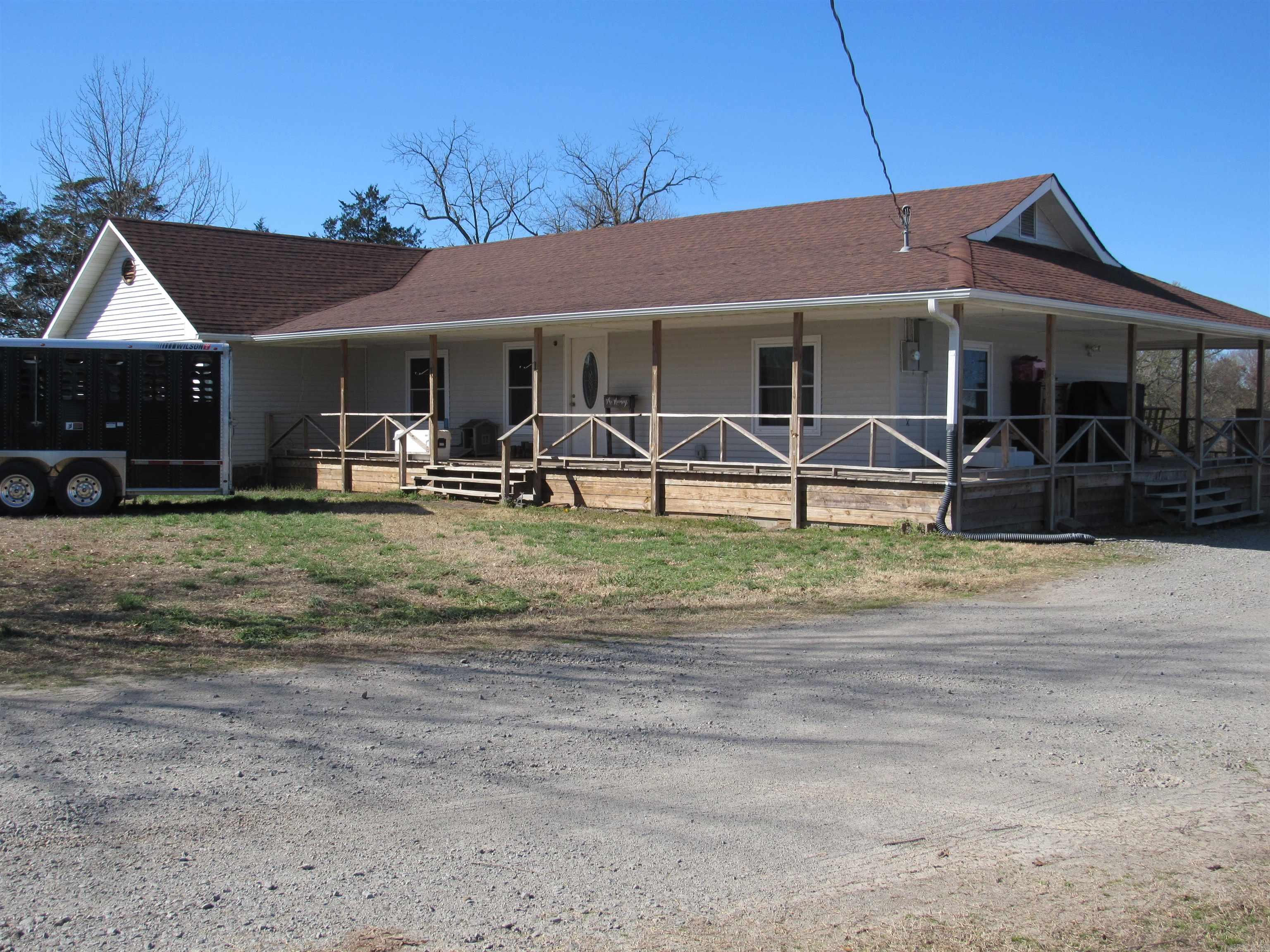 CATTLE AND WILDLIFE SHARE THIS FAMILY FARM WITH THE OWNERS. BEAUTIFULLY UPDATED JUST A FEW YEARS AGO. 50' X 60' STORAGE BARN FOR ALL THE HAY THIS ACREAGE PRODUCES. RECENT IMPROVEMENTS INCLUDE: ROOF, WINDOWS, COVERED WRAP PORCH ON 3 SIDES, 10' X 16' SCREENED PORCH SOLID SURFACE COUNTERS, RANGE, REFRIGERATOR, DISHWASHER, SEPTIC TANK AND LAMINATE FLOORING.