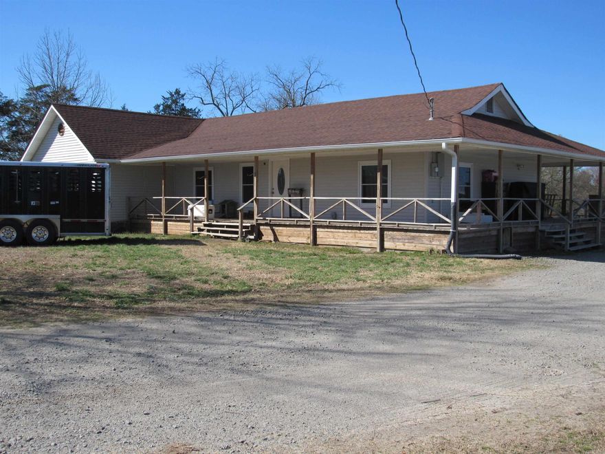 CATTLE AND WILDLIFE SHARE THIS FAMILY FARM WITH THE OWNERS.  BEAUTIFULLY UPDATED JUST A FEW YEARS AGO.  50' X 60' STORAGE BARN FOR ALL THE HAY THIS ACREAGE PRODUCES.  RECENT IMPROVEMENTS INCLUDE: ROOF, WINDOWS, COVERED WRAP PORCH ON 3 SIDES, 10' X 16' SCREENED PORCH SOLID SURFACE COUNTERS, RANGE, REFRIGERATOR, DISHWASHER, SEPTIC TANK AND LAMINATE FLOORING.